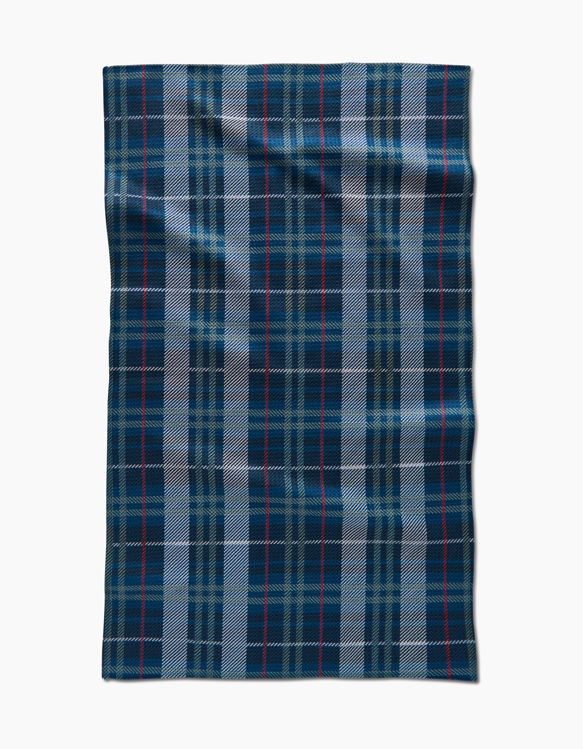 The Becki Owens Scotty is a rectangular wool blanket, crafted from recycled materials, featuring a blue, black, and white tartan plaid with thin red lines, displayed flat on a white background.