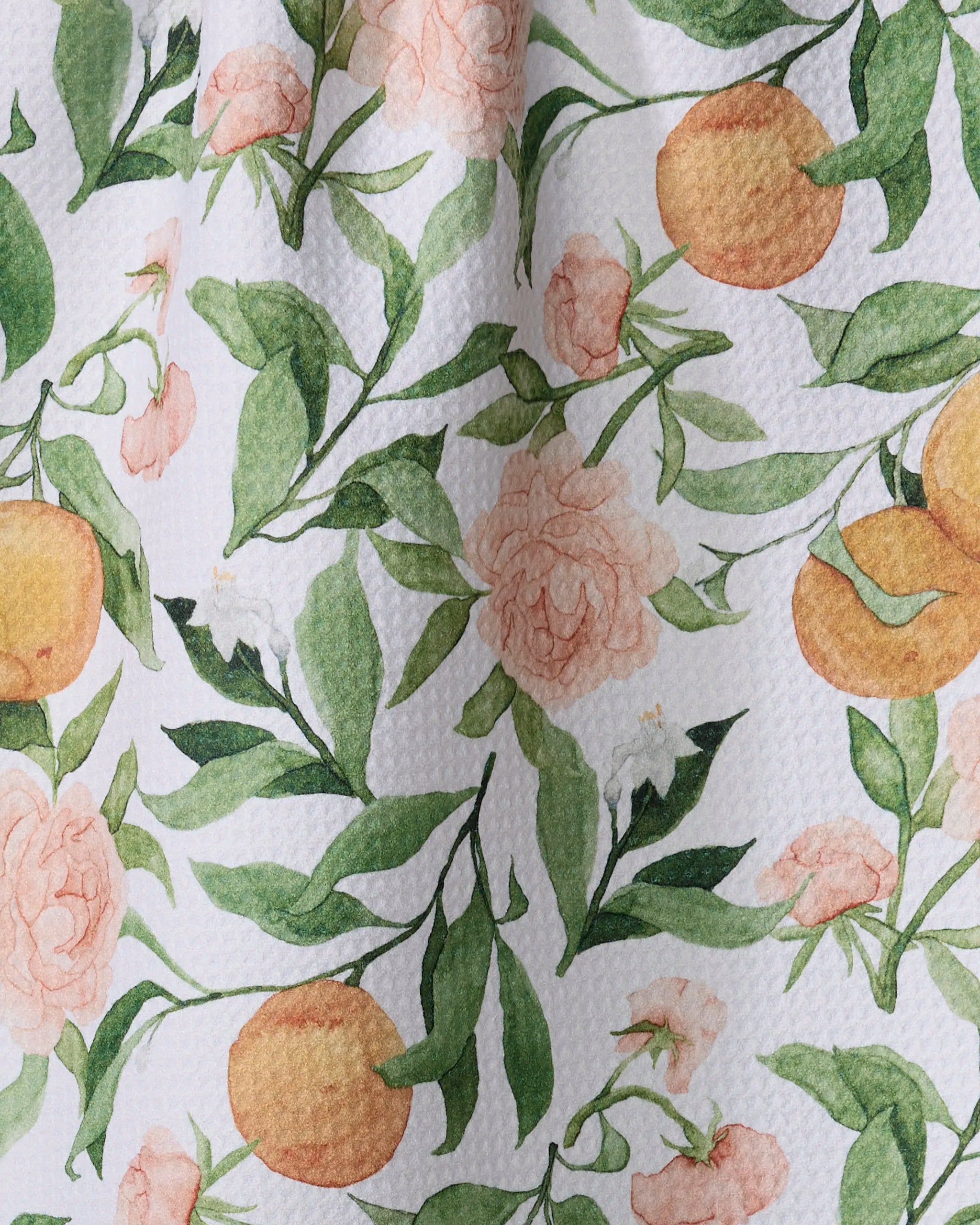 Aubrey Fairchild’s "A Peony For Your Thoughts" is a textured white recycled kitchen towel with a watercolor-style design of green leaves, peach flowers, and orange fruit, adding a summery botanical touch to your space.