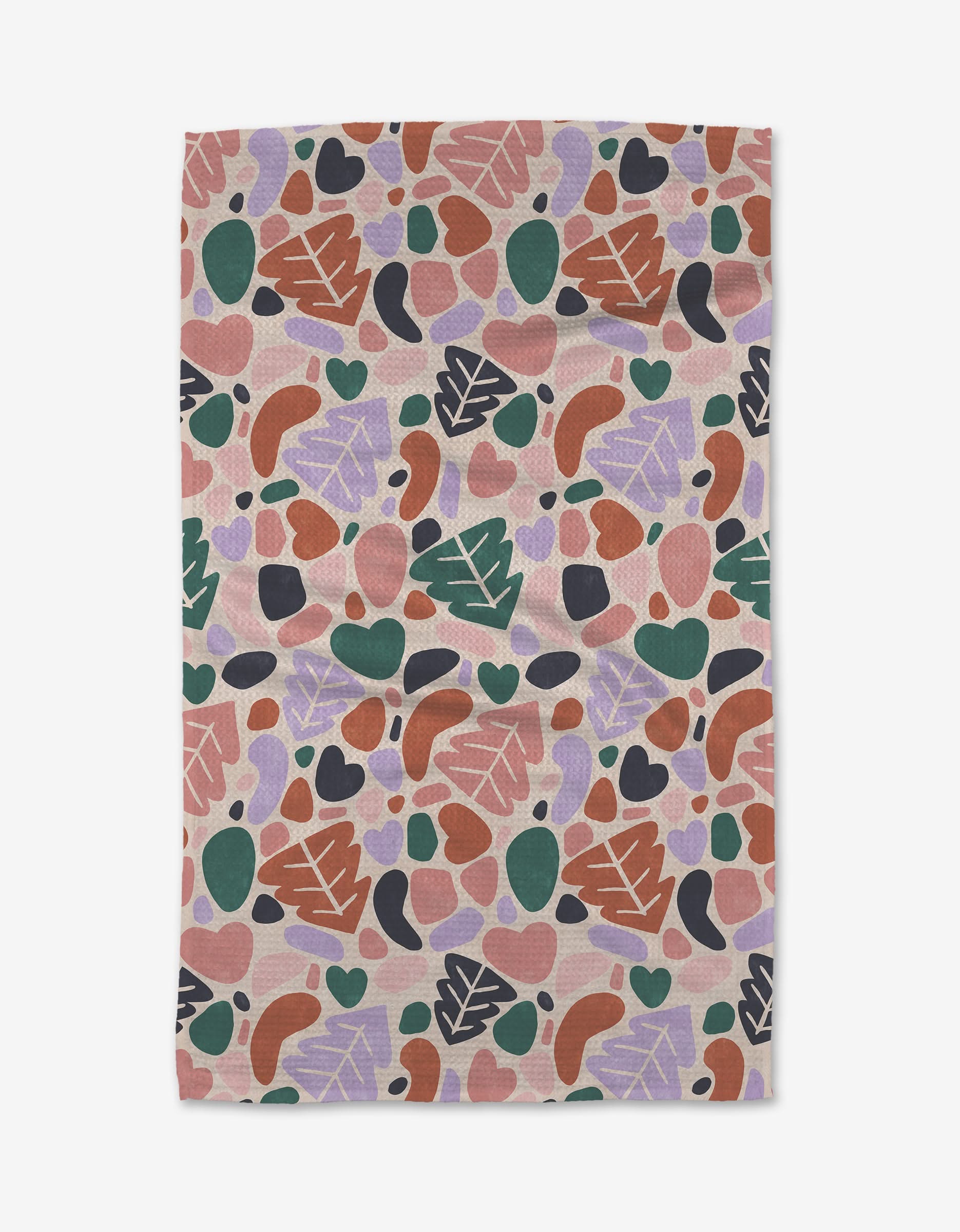 The Abstract Christmas kitchen towel by Claire Iglesias features a vibrant abstract design with hearts, leaves, ovals, and curves in pink, green, purple, red, and black on a light background.