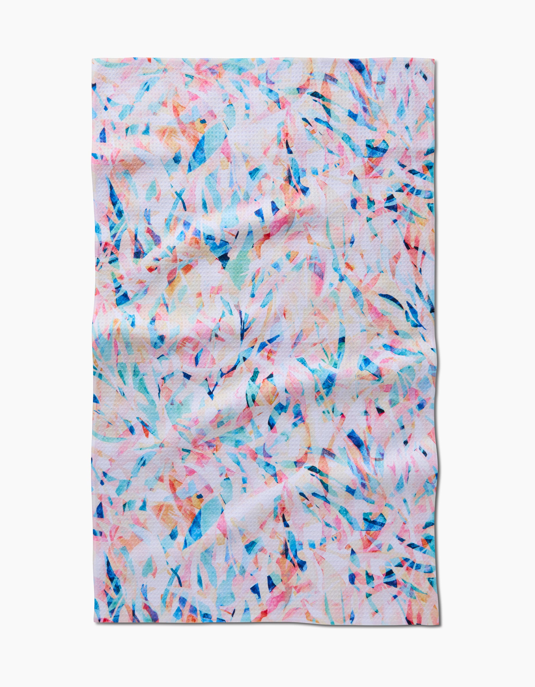 The Abstract Jungle tea towel by Rachel Parker features a colorful abstract pattern with scattered blue, orange, and pink shapes on a white background. The rectangular towel is shown slightly wrinkled and lying flat on a white surface.