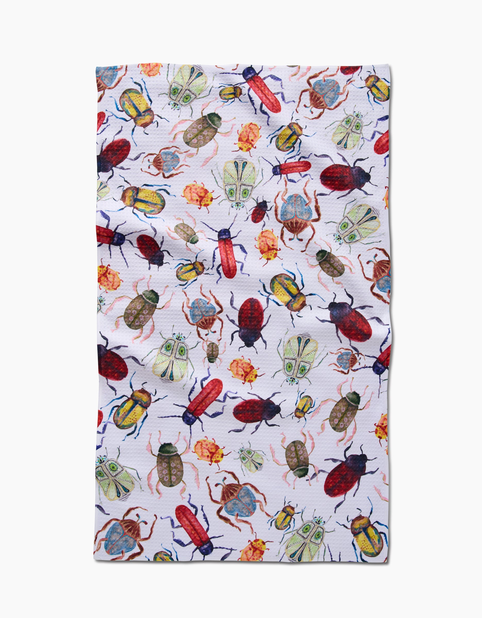 The African Beetles tea towel by Taryn Brennan features a colorful, scattered pattern of illustrated beetles, moths, and insects in red, green, yellow, and blue on white Geoweave fabric with a slightly wrinkled look.