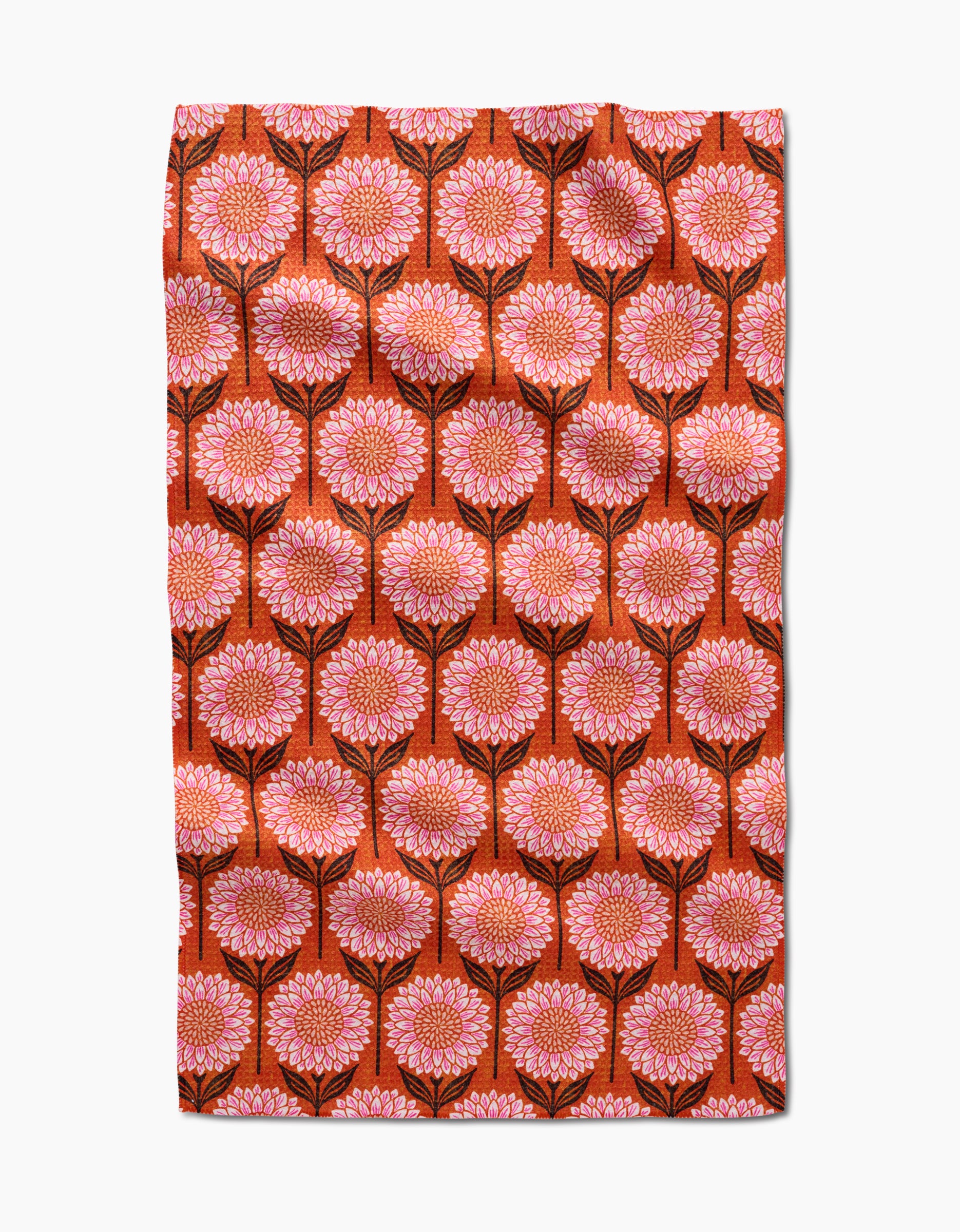 The Amy MacCready Amber tea towel is made from recycled materials and features large pink and orange flowers with black stems on deep orange, forming a symmetrical, ultra-absorbent surface.