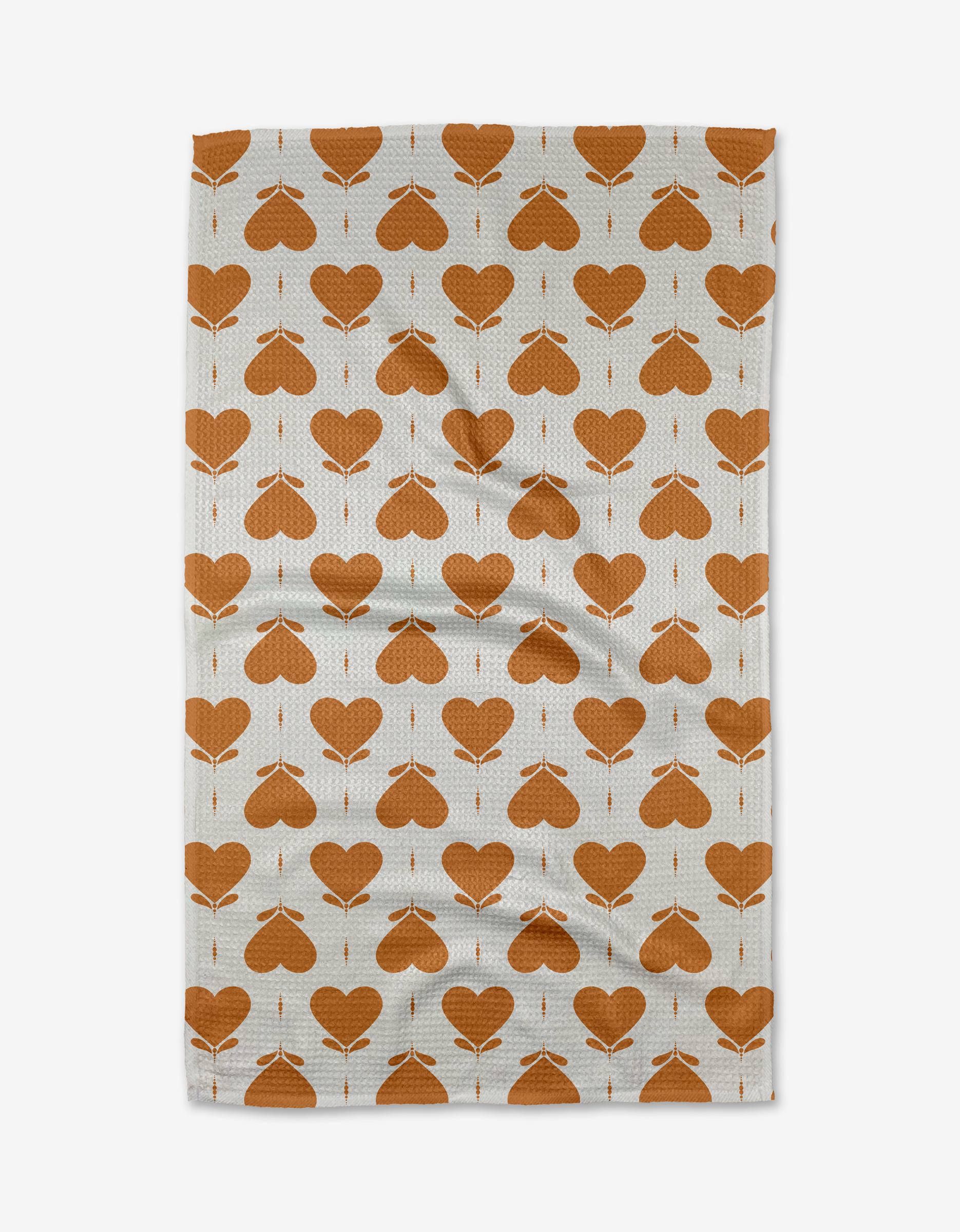 The Amor tea towel by Danelys Sidron features a repeating orange heart and arrow pattern in neat rows. Made from quick-drying recycled materials.
