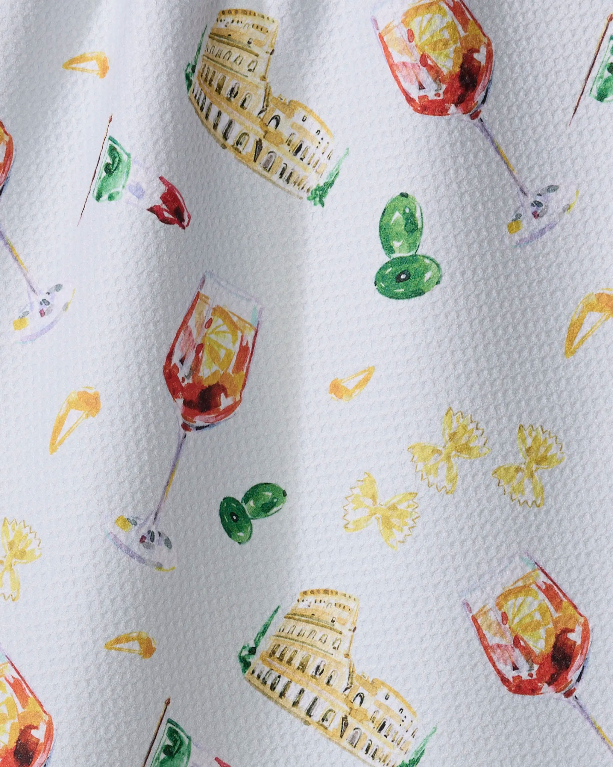 The Aperol in Rome recycled kitchen towel by Travel Write Draw (Meagan Morrison) features a textured white surface with watercolor illustrations of wine glasses, pasta, olives, Italian flags, and the Colosseum in a scattered pattern.