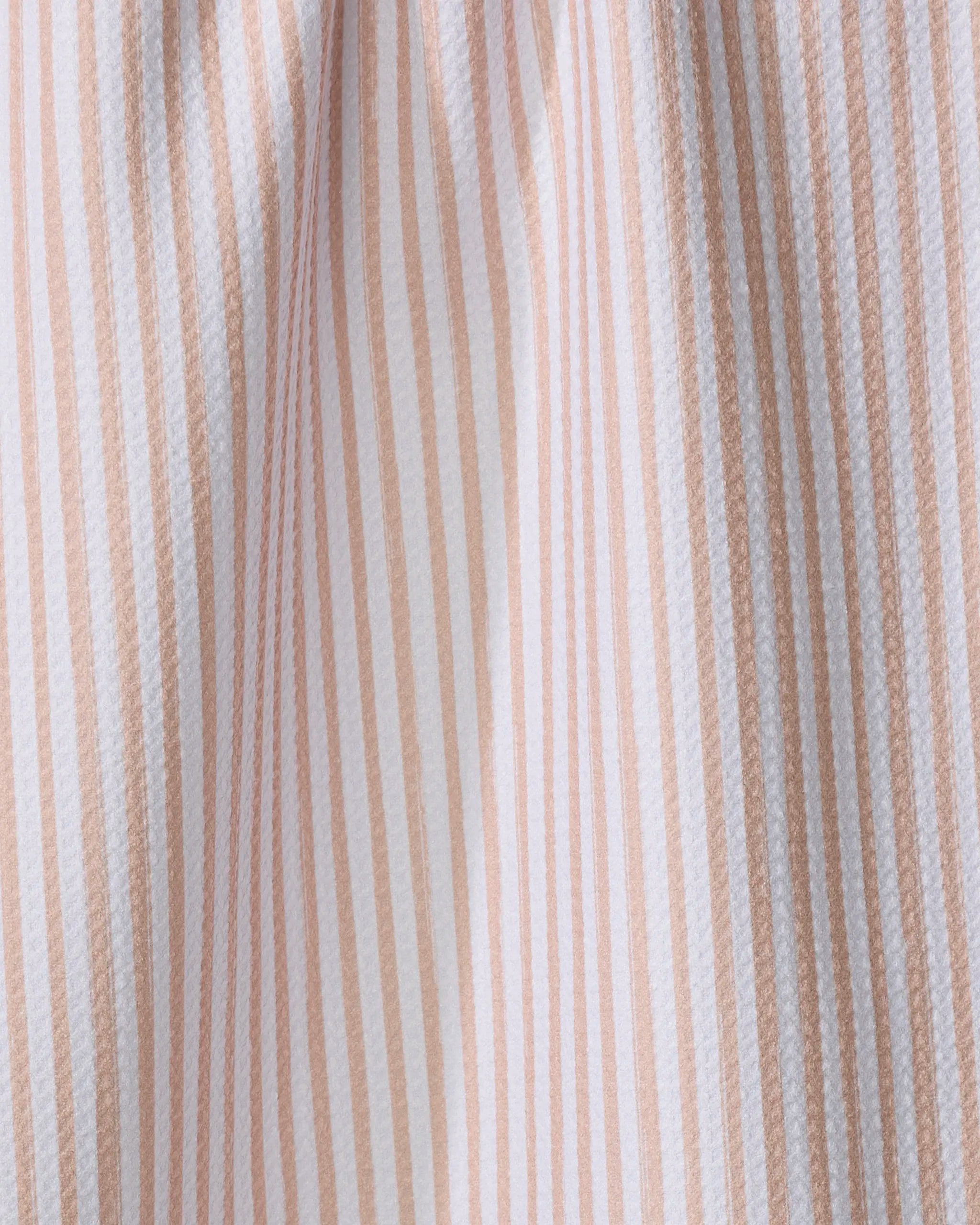 A close-up of the Kailee Wright Apricot quick-drying towel features vertical beige and white stripes and a slightly gathered texture.