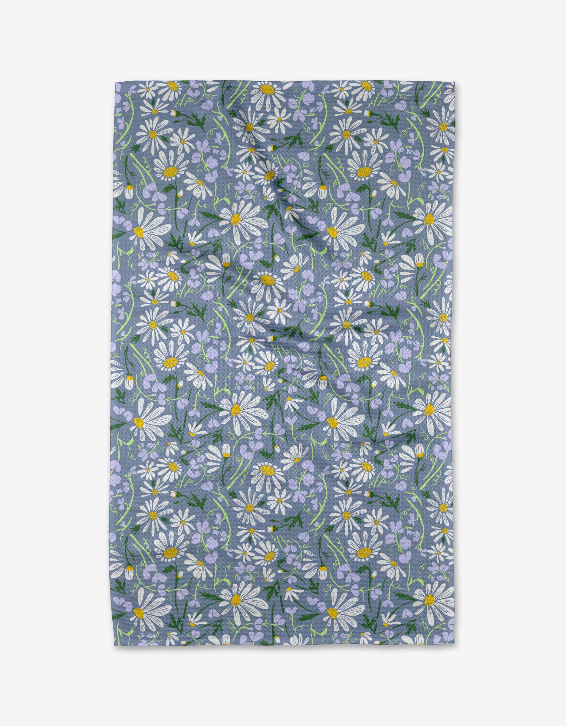 The April Tea Towel by Elisabeth Wing features white and purple daisies with green stems on a blue background, crafted from Geoweave™ fabric and shown laid flat on a white surface.