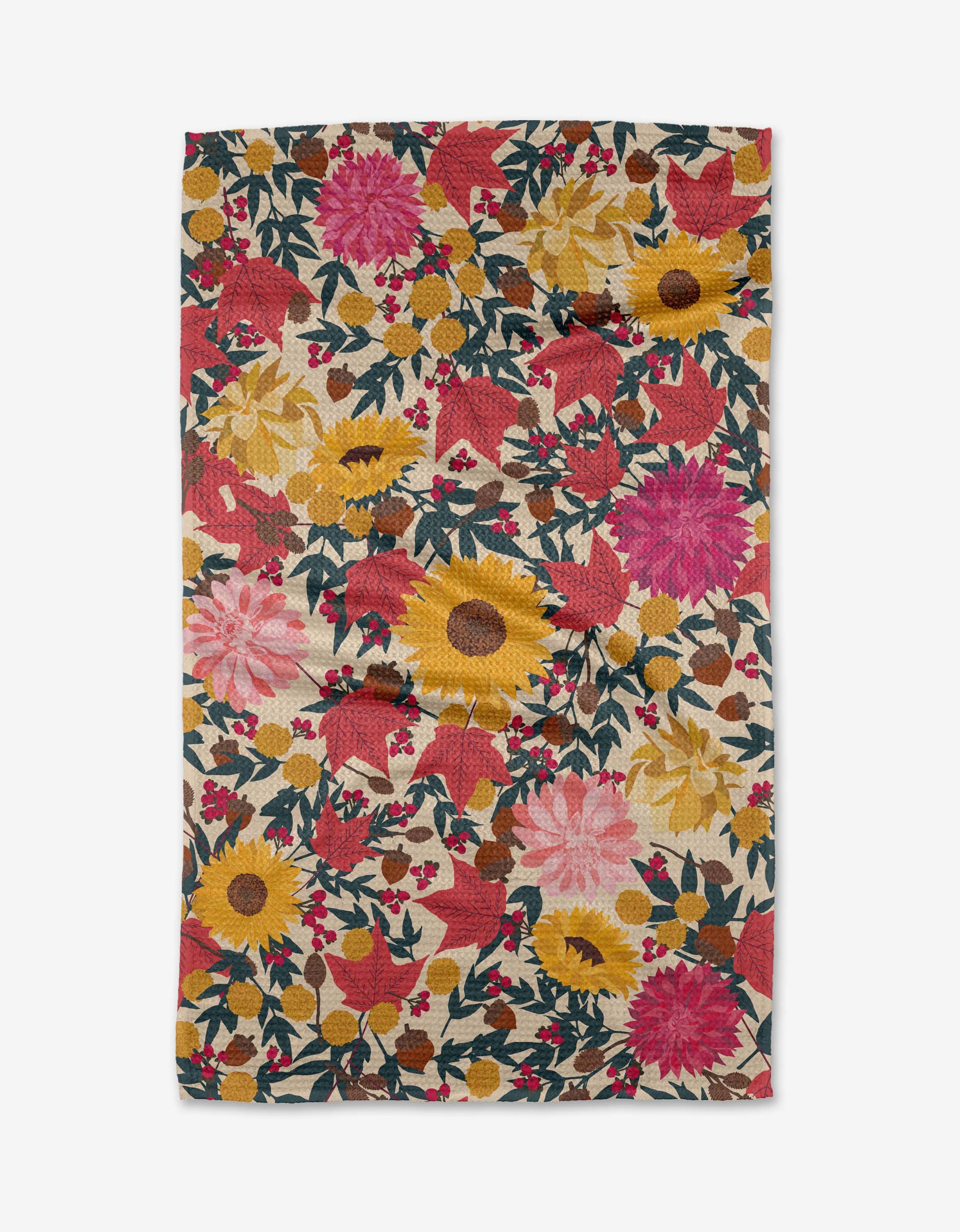 The Rebecca Bobko Autumn Blooms Geoweave™ tea towel features a vibrant floral pattern of red, pink, and yellow flowers with green leaves and berries on a cream background. The rectangular fabric has a slightly wrinkled appearance.