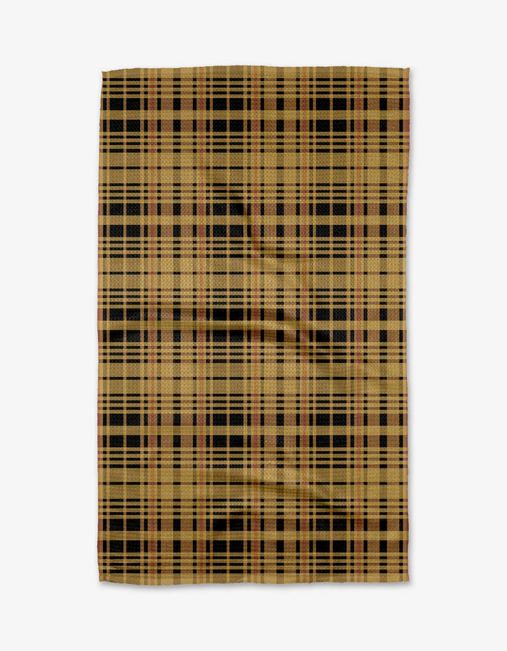 The Autumn Plaid mat by Danelys Sidron features a tan base with black, brown, and red plaid, crafted from recycled materials and shown flat on a white surface.