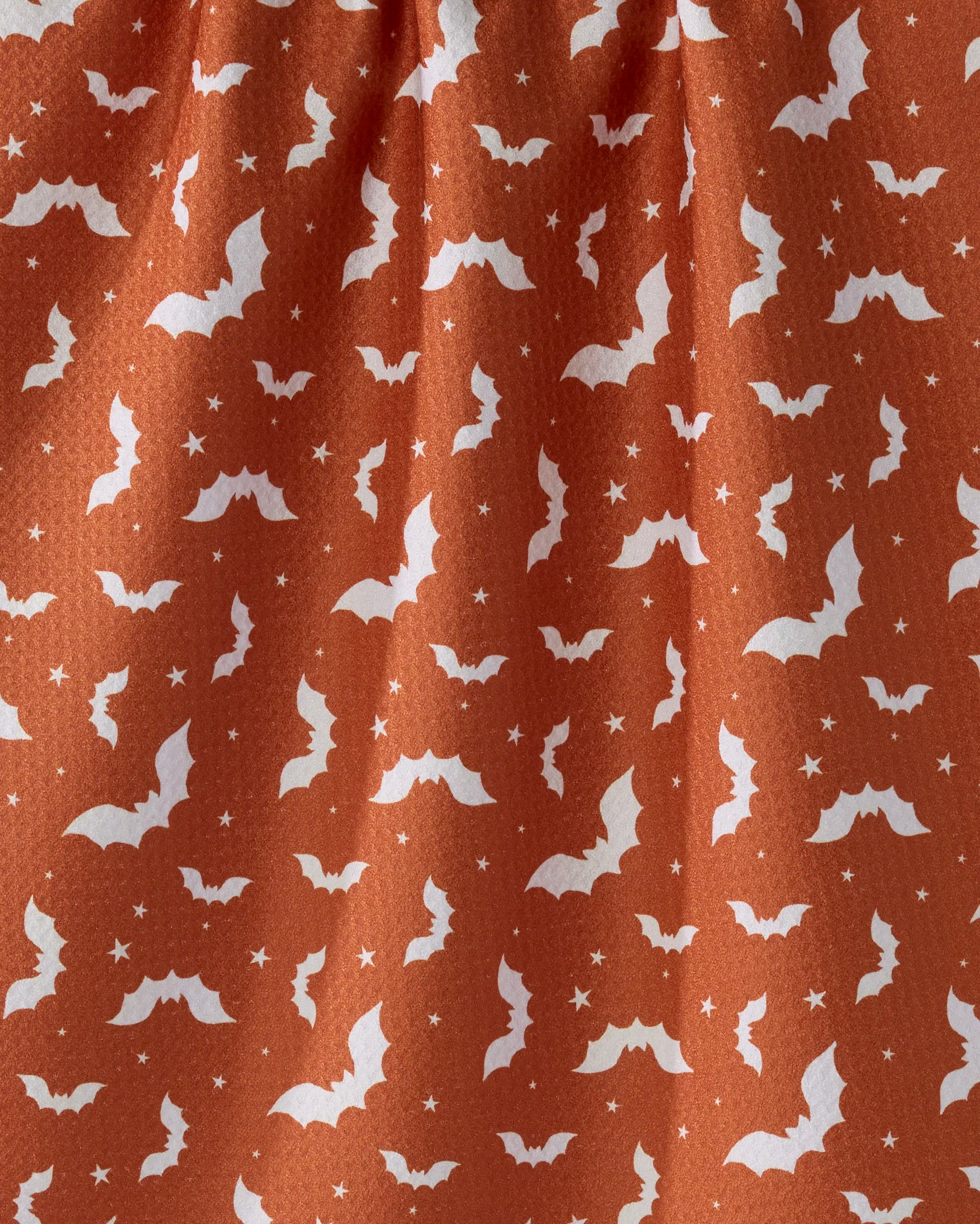 The Geometry Batty Night kitchen towel features orange fabric with white bats and stars, adding a festive, eco-friendly Halloween touch to your décor.