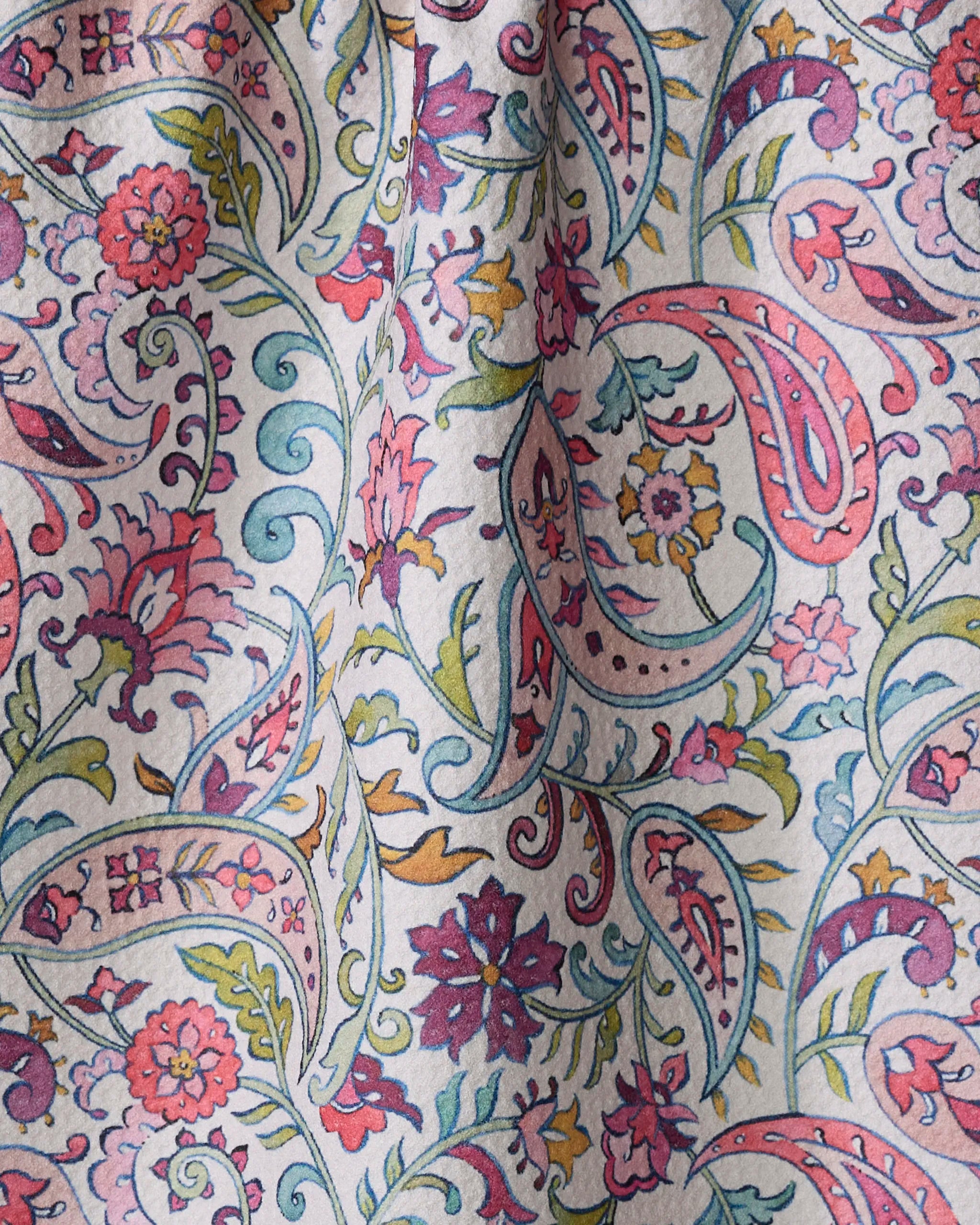 Bazaar by Maayan Alper-Swan is a kitchen tea towel with a colorful floral and paisley design in pink, purple, blue, and yellow on a light background. Made from recycled materials, the fabric features soft, natural folds.