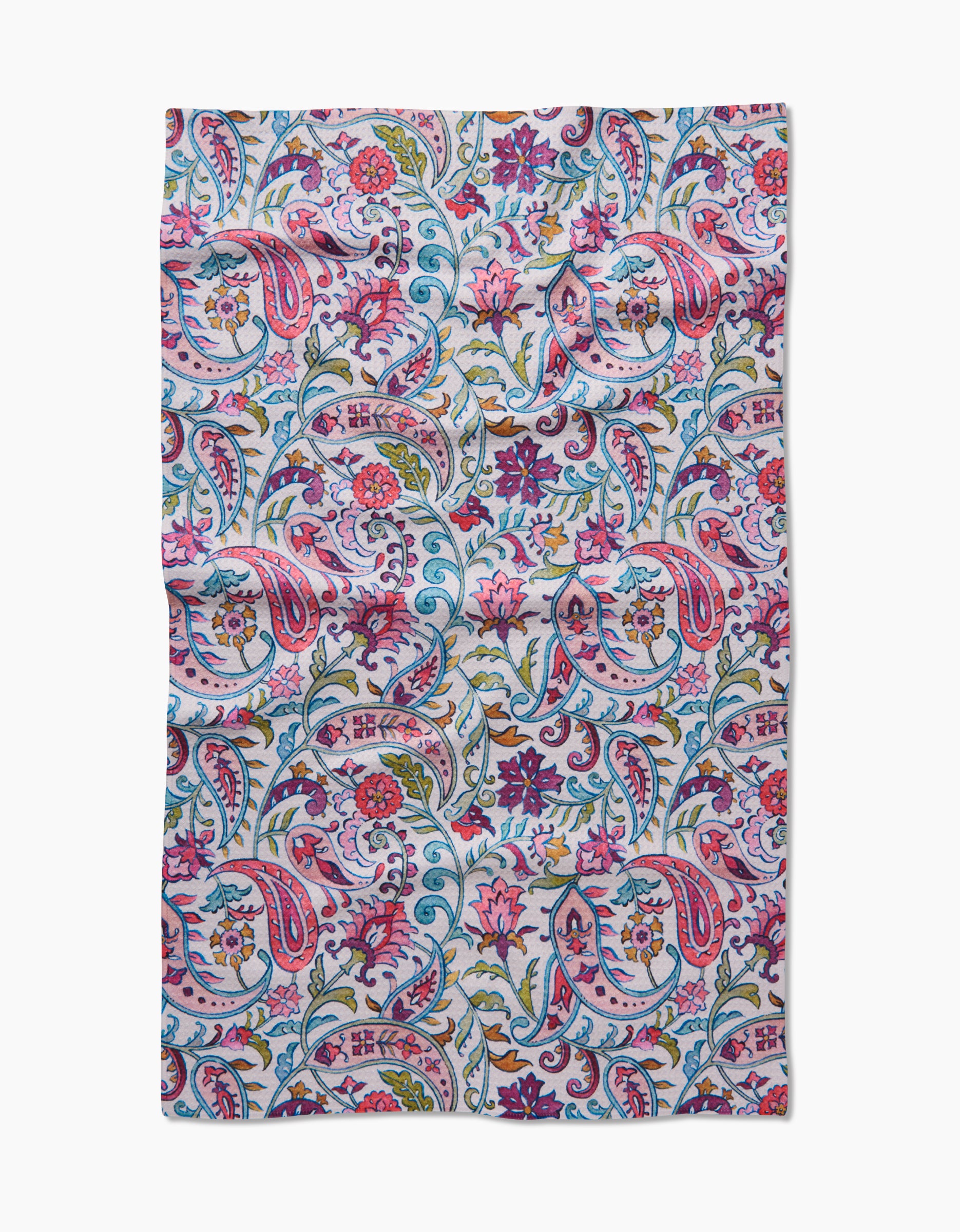The Bazaar Kitchen Tea Towel by Maayan Alper-Swan features a paisley and floral print in pink, purple, blue, and green on white. Made from recycled materials, the rectangular fabric has a slightly wrinkled look.