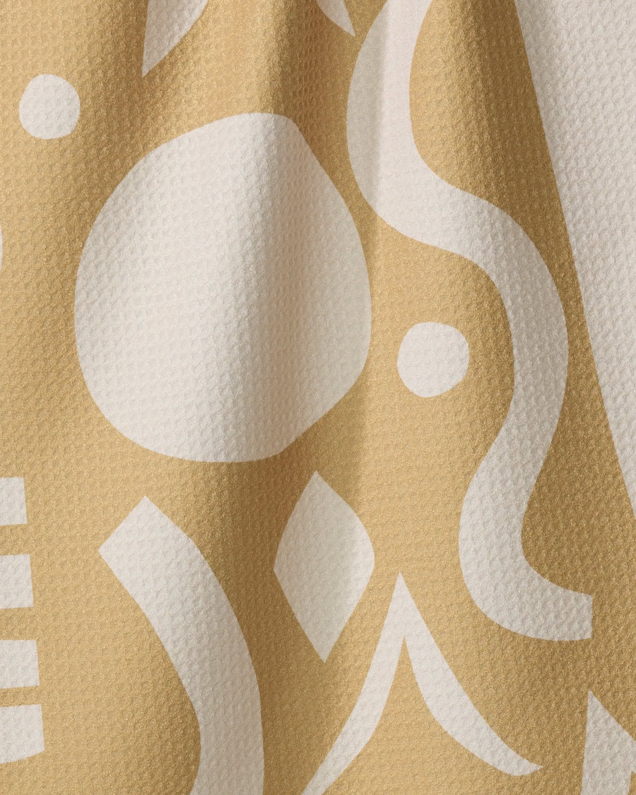 A close-up of Beach Walk by Elizabeth Edwards shows textured fabric made from recycled materials with an abstract white and beige pattern featuring geometric and organic shapes.
