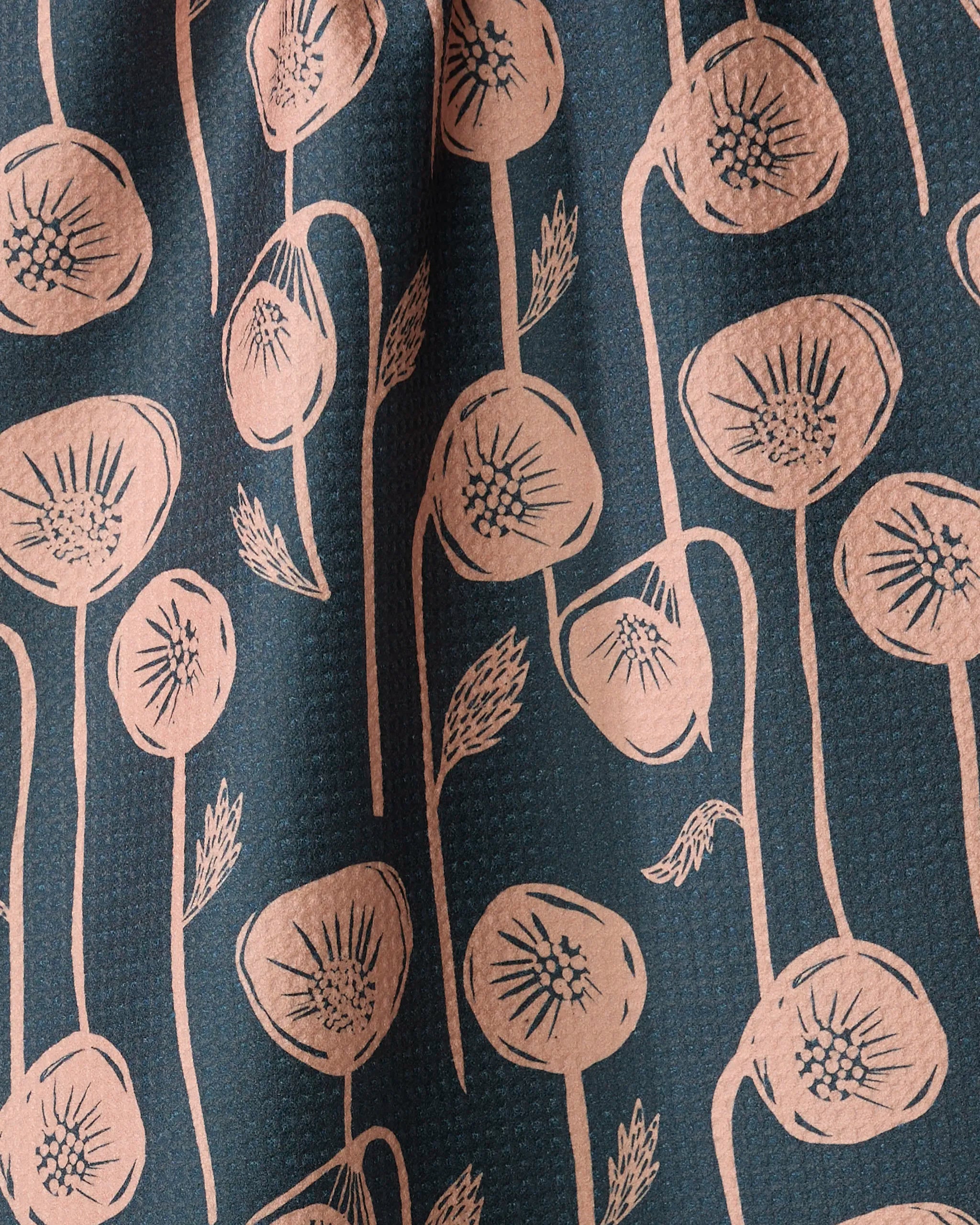 Belgian Poppies by Elisabeth Wing is a tea towel made from recycled materials, featuring a repeating pattern of stylized pinkish-beige seed pods and stems on a dark background. The quick-drying fabric boasts wavy lines and textured folds for added appeal.