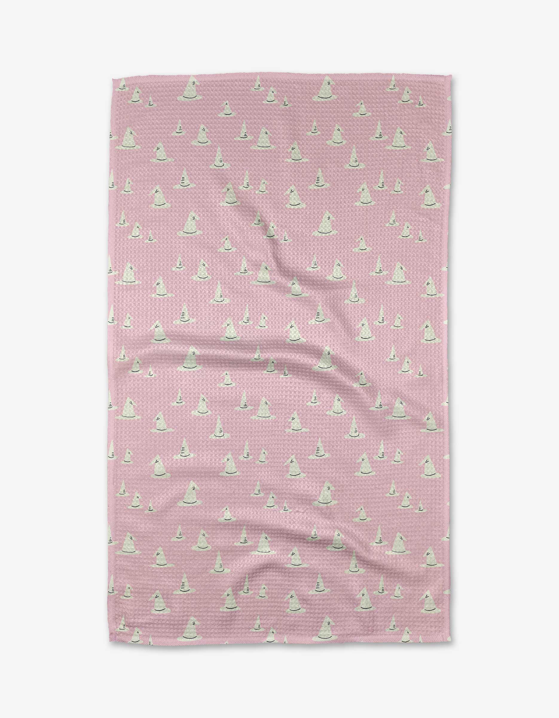 The Belladonna blanket by Amy MacCready is pink with a textured finish, made from recycled materials. It features a repeating pattern of small white cartoon llamas in green party hats and is displayed laid flat on a white background.