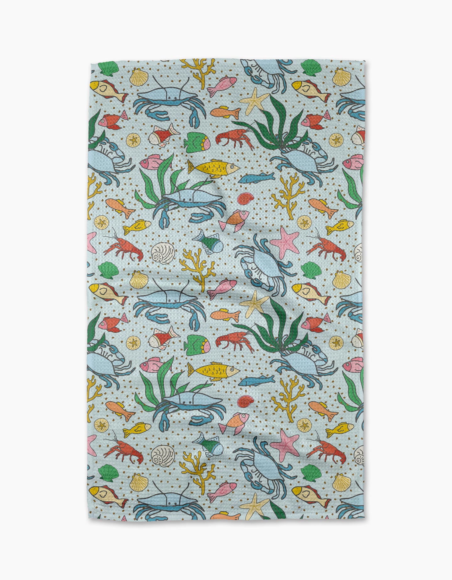 The Mindfulnice “Beneath the Waves” tea towel has a vibrant underwater scene with sea life on a light background—perfect for adding color to your kitchen décor.
