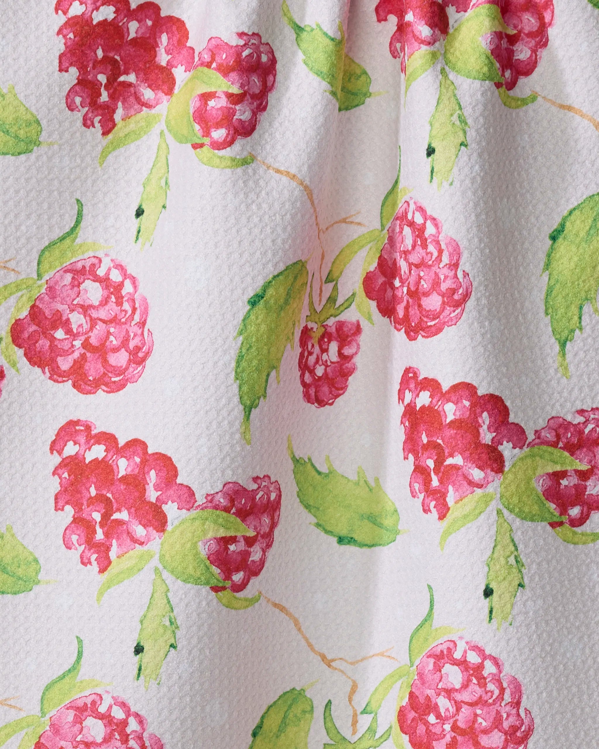 Close-up of Elena Fay's Berry Bright recycled kitchen towel, featuring a white textured surface with watercolor-style raspberries and green leaves for a fresh botanical look.