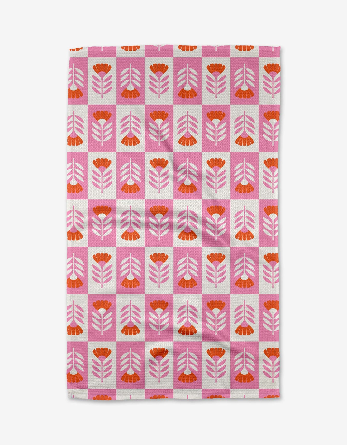 The Berry Flower Patch tea towel by Charlie Rowan Designs features a retro-inspired pink and red floral pattern with a pink grid on white. Made from ultra-absorbent recycled materials, it adds vibrant style to any kitchen.