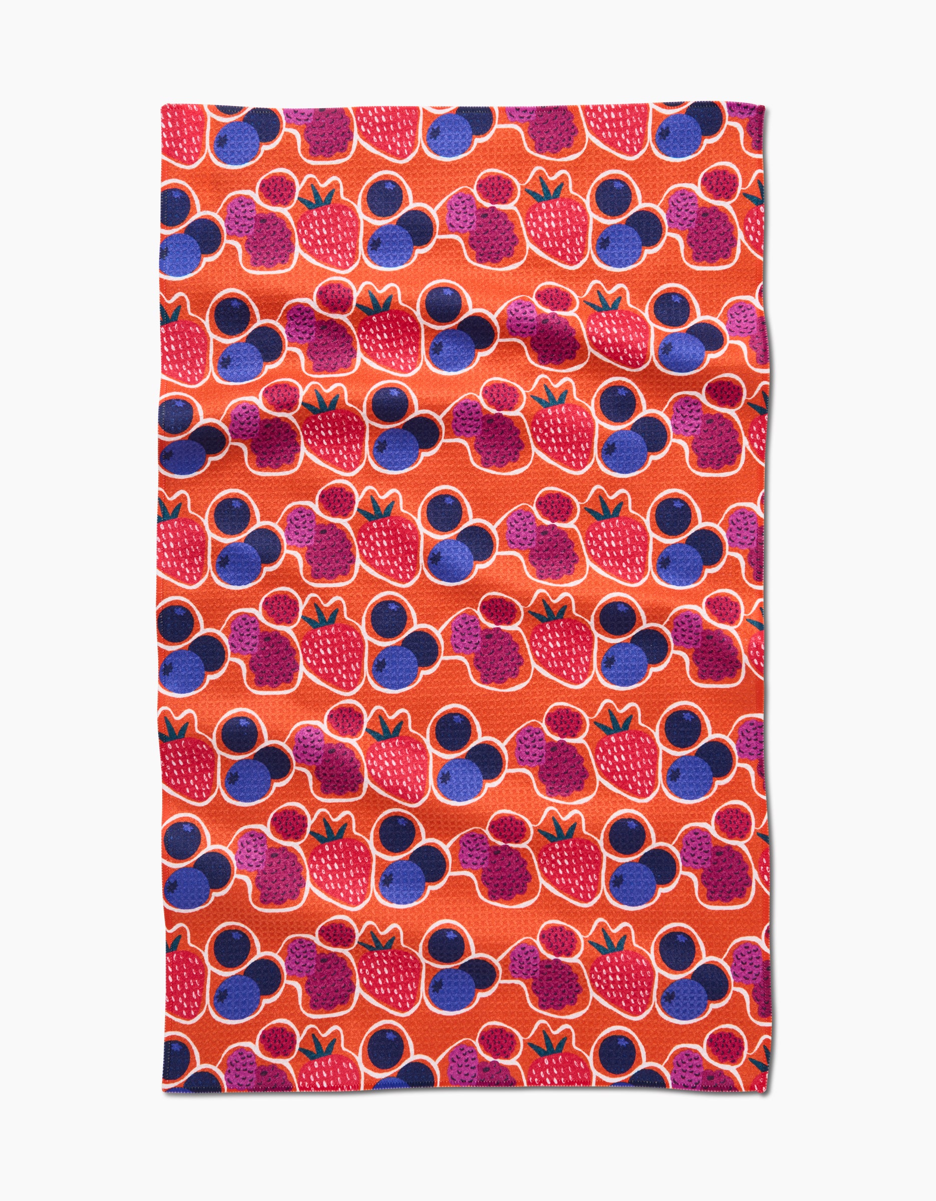 The Berrylicious tea towel by Lizzie Clark features a repeating pattern of red strawberries and purple Mickey Mouse-shaped circles on an orange background, crafted from Geoweave fabric in a bright rectangular design.