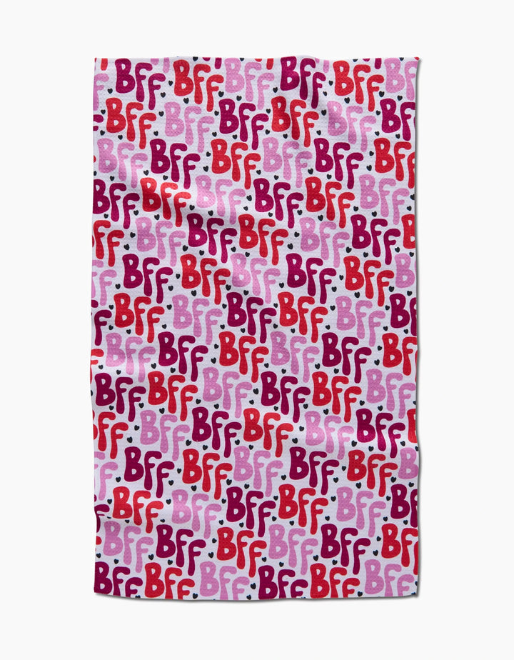 The Best Friends Forever blanket by Hufton Studio features a repeating BFF pattern in red, pink, and purple text on a light pink background with white dots, styled like a charming tea towel for cozy moments.
