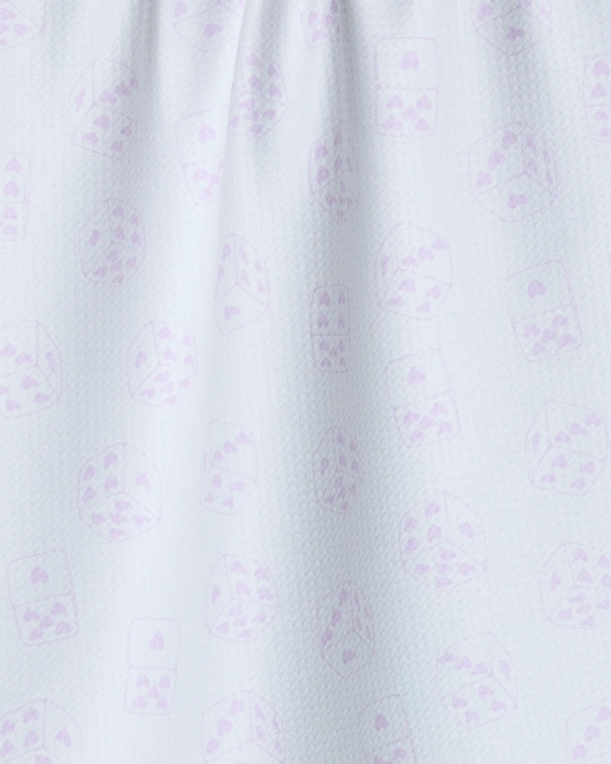 A close-up of the Bet on You White tea towel by Geometry shows light blue, quick-drying recycled fabric with a subtle pattern of playing cards and dice in faint purple.