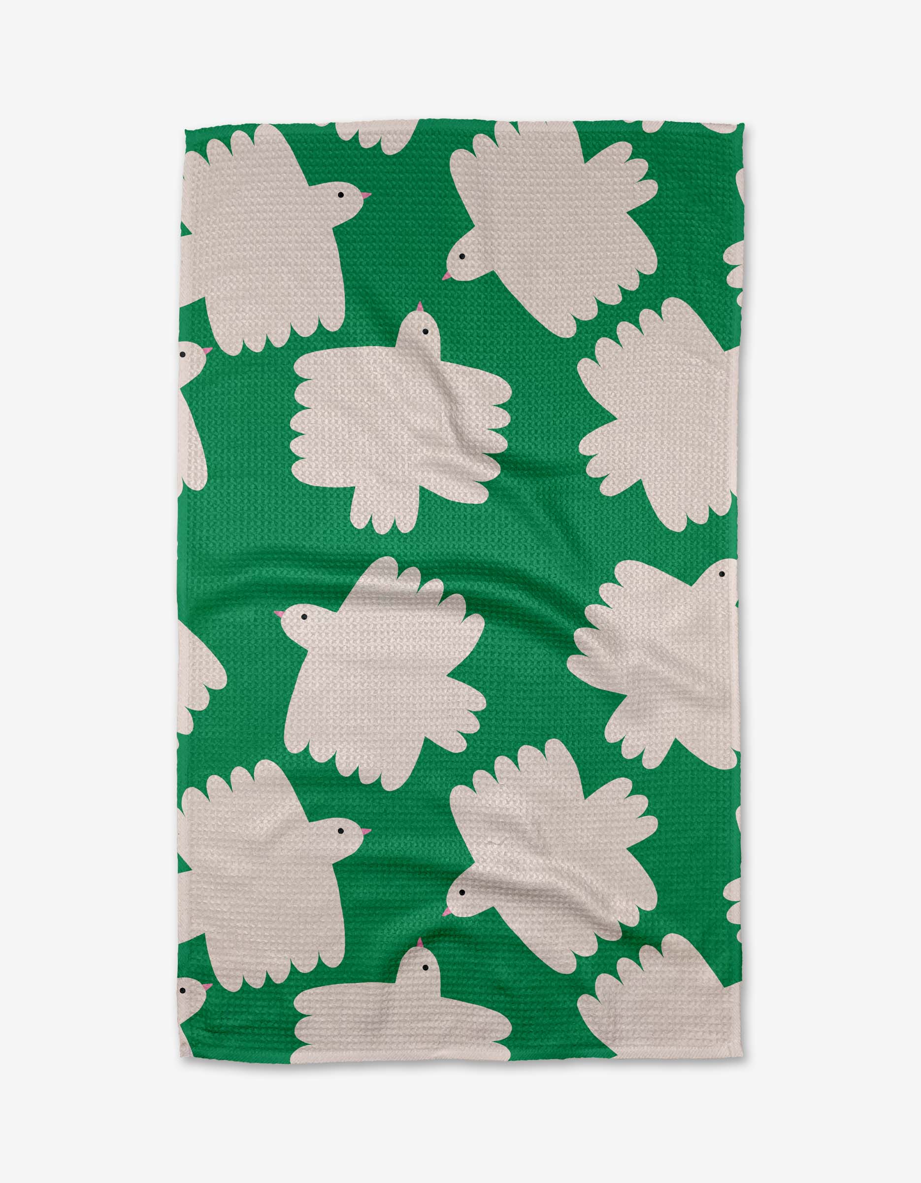 The Birds tea towel by Jennifer Bouron is green, made from recycled materials, and features white abstract bird-like shapes with black eyes in varied directions.