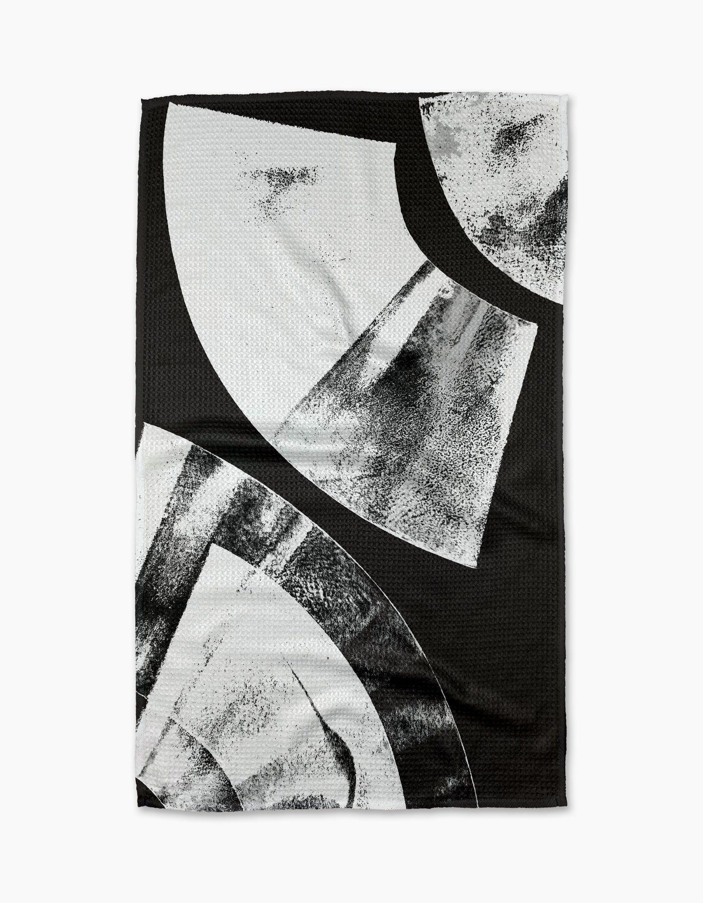 The Skye Walker Black Graphite Shift is a black ultra-absorbent tea towel with bold abstract white and gray geometric shapes and textured brushed patterns, offering a modern, artistic look.