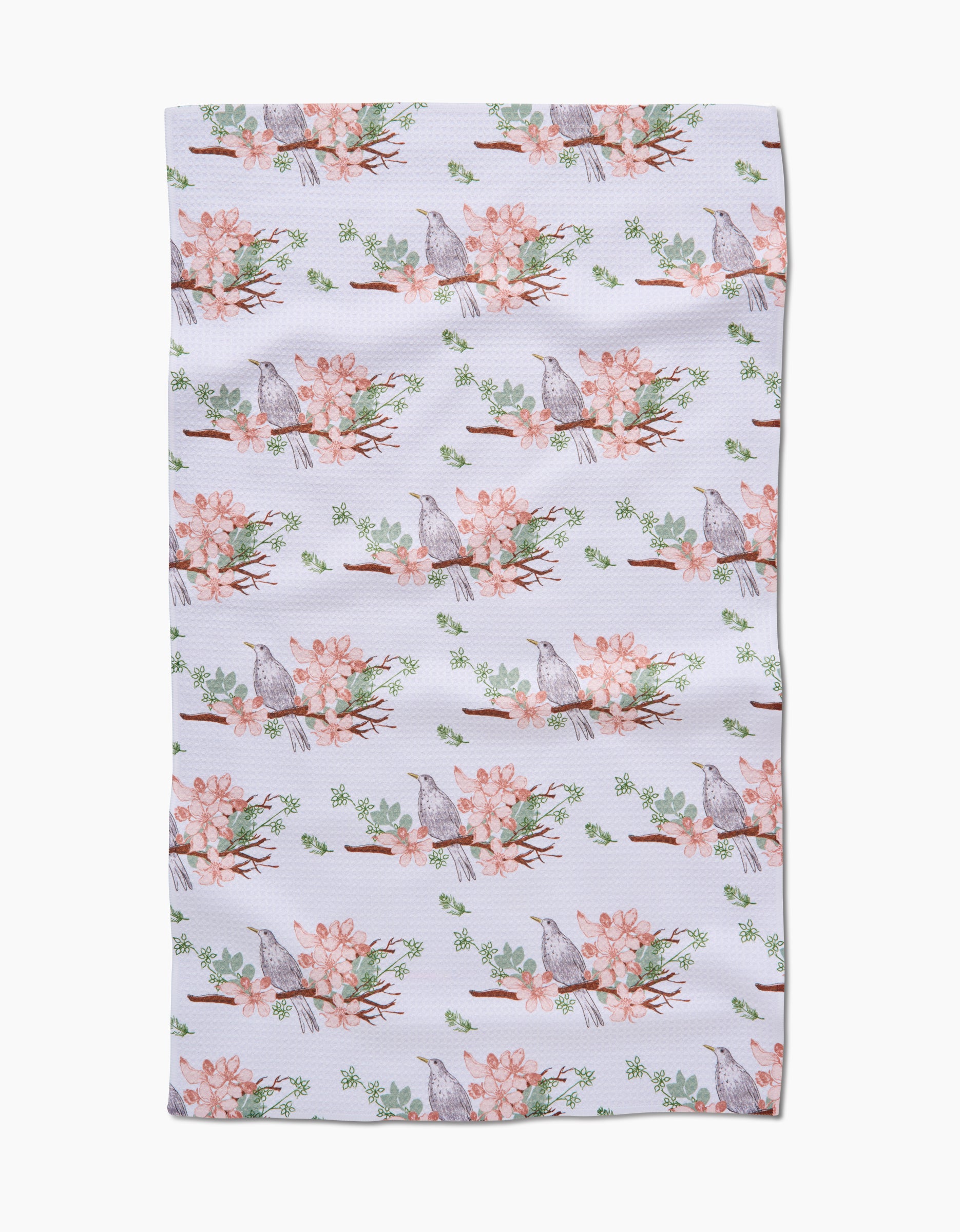 The Linda Fox Blackbird and Blossom towel features ultra-absorbent Geoweave fabric with a white background and a repeating pattern of gray birds on branches with pink flowers and green leaves.