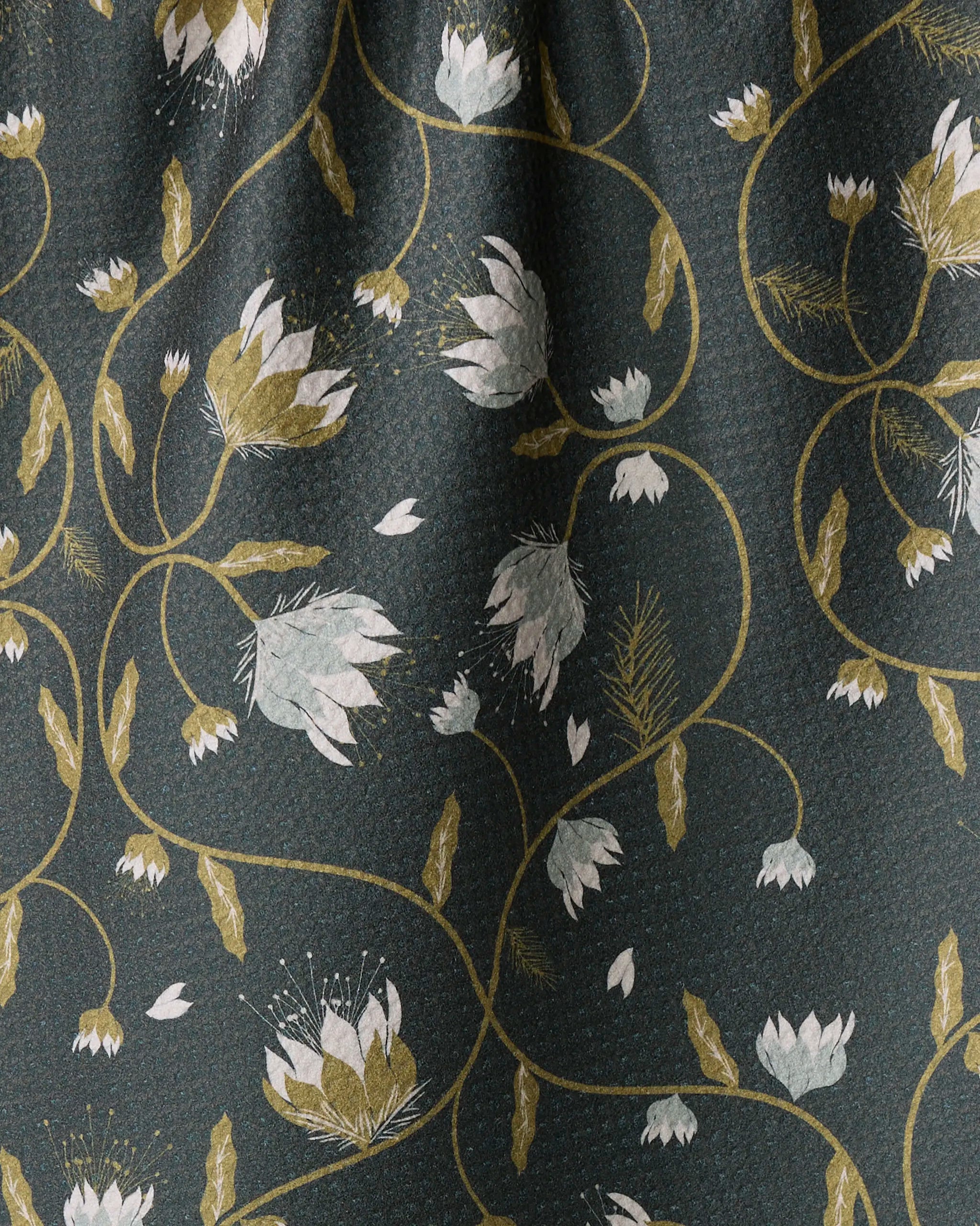 Close-up of the Blockprint Floral fabric by Ash Cascade—dark green with white and light green flowers and yellow-green vines, creating an elegant, flowing pattern. Ideal for a soft, quick-drying towel with gentle folds.