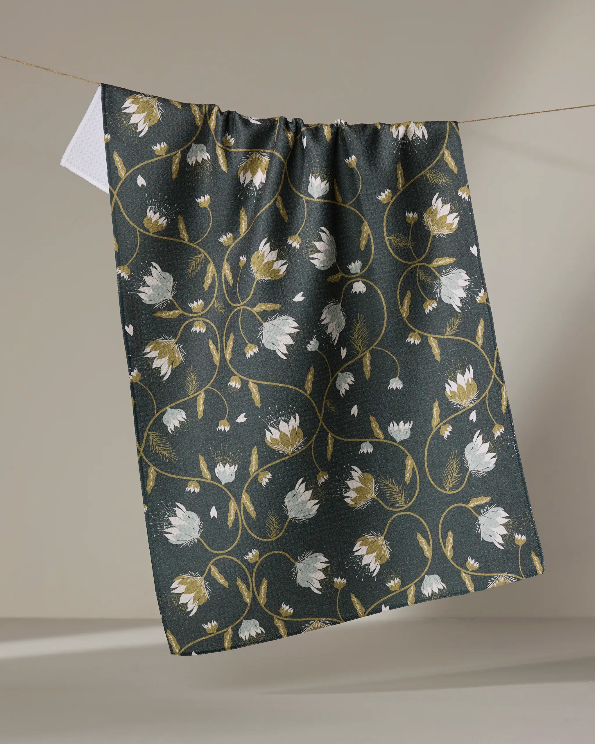 The Ash Cascade Blockprint Floral quick-drying towel hangs on the clothesline, ready for its next use.