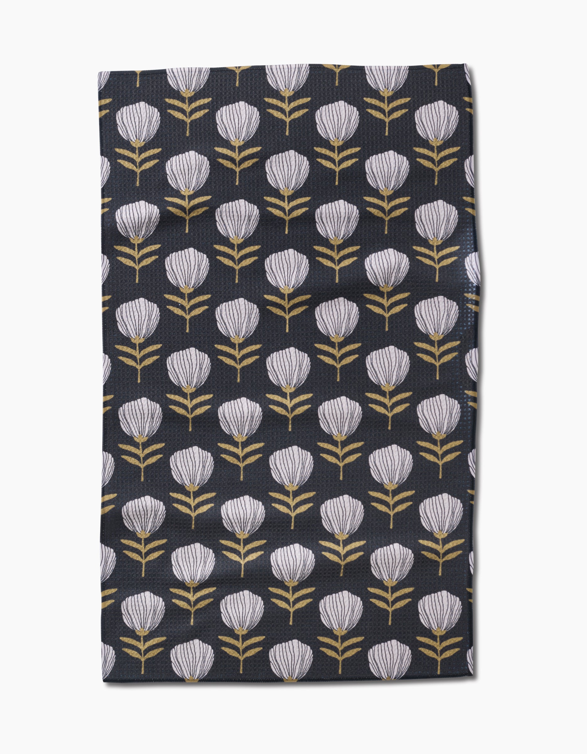 The Blomma tea towel by Anna Christian features stylized white flower heads with yellow stems in neat rows on dark fabric, made from recycled materials.