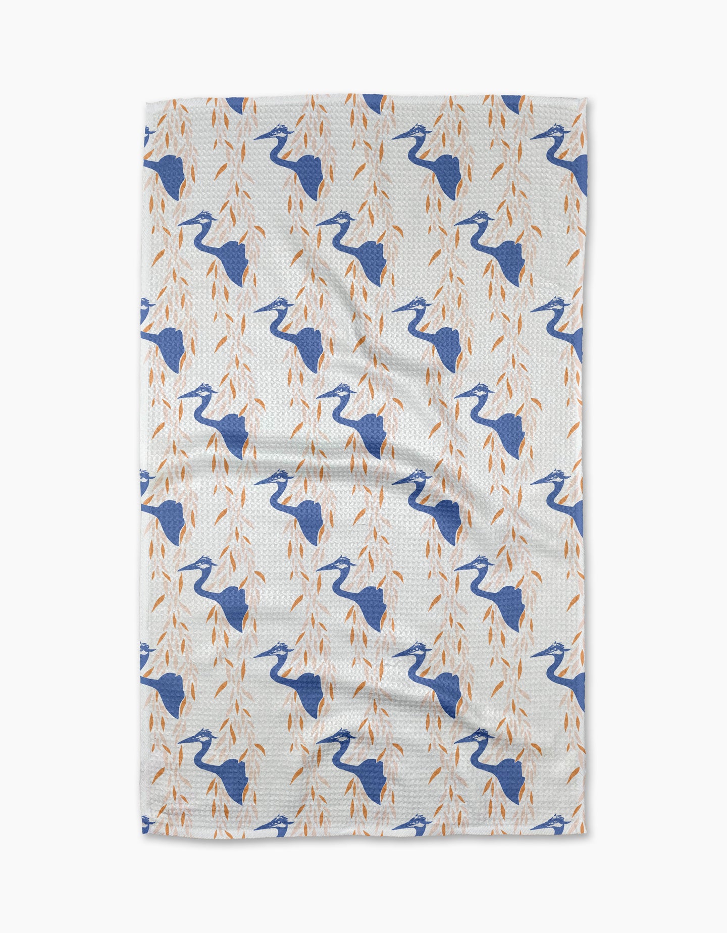 The Blue Heron tea towel by Elisabeth Wing showcases blue herons among orange leafy branches, arranged in a diagonal pattern across white eco-friendly fabric.