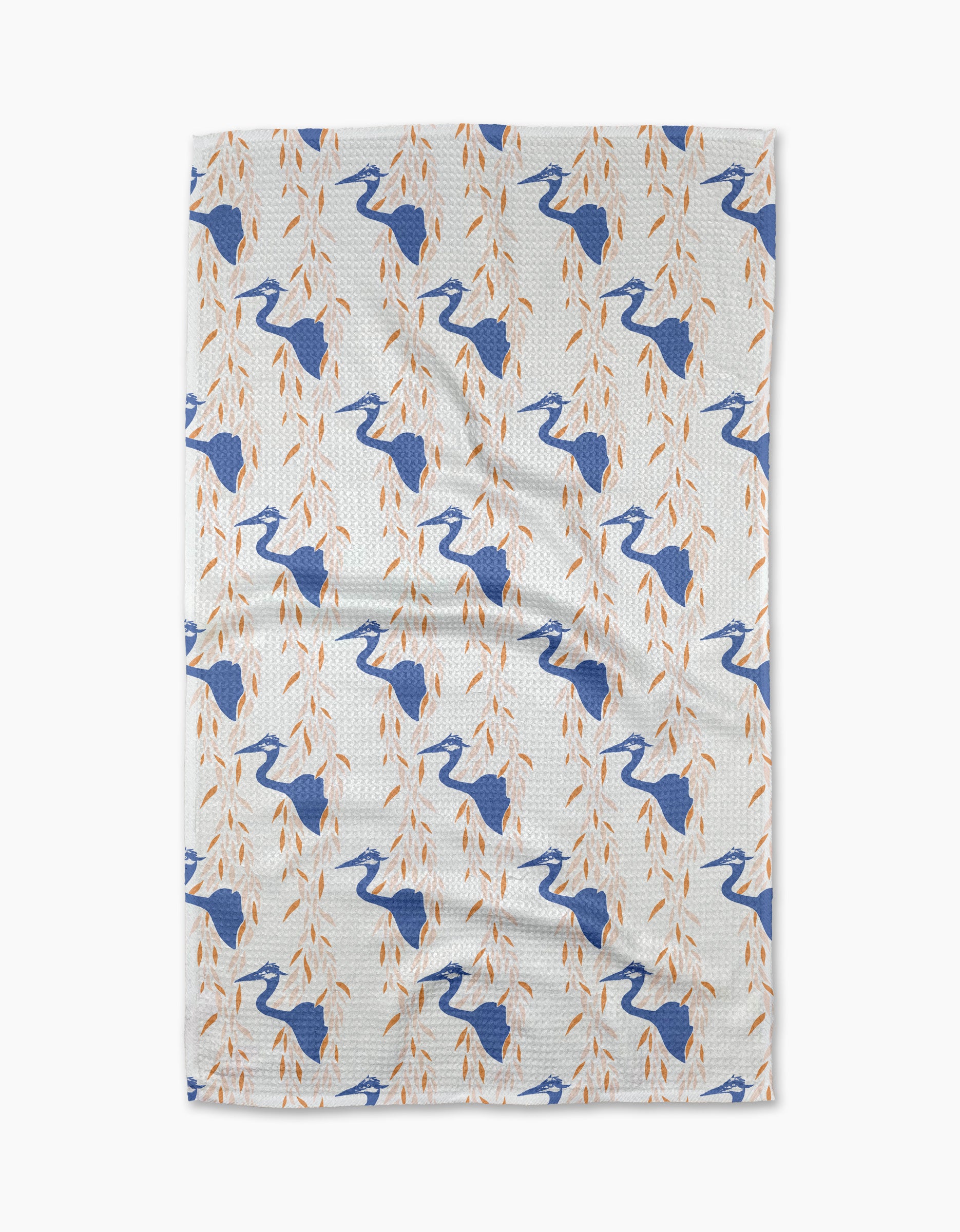 The Blue Heron tea towel by Elisabeth Wing showcases blue herons among orange leafy branches, arranged in a diagonal pattern across white eco-friendly fabric.
