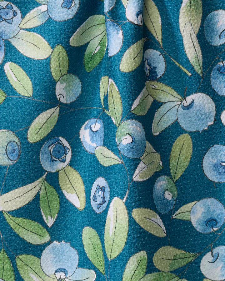 Blueberry Hill by Sara Mari features a blue and green watercolor-style blueberry and leaf print on teal. The slightly wrinkled, textured fabric is perfect for kitchen or tea towels.