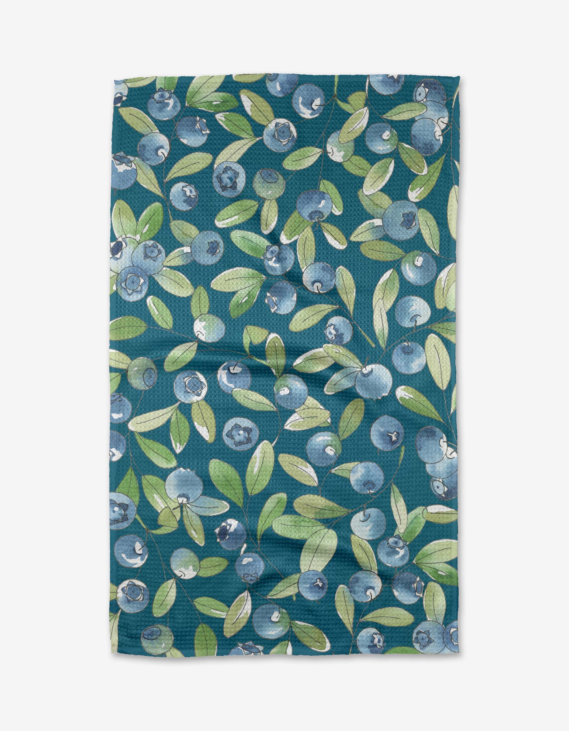 The Sara Mari Blueberry Hill tea towel features a blueberry and green leaf design on dark teal, crafted from soft Geoweave fabric and displayed flat with subtle creases.