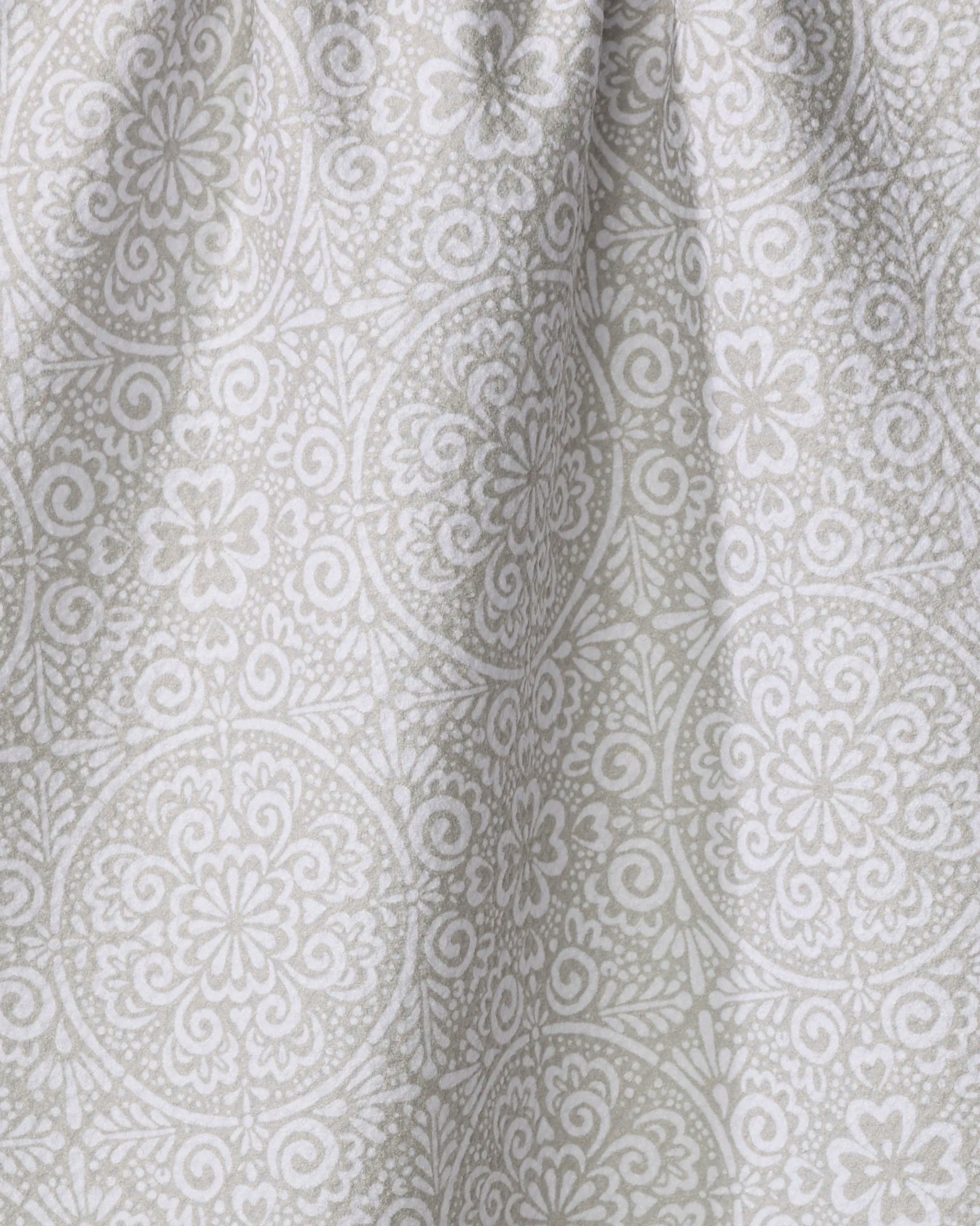 Close-up of the Kris Ruff Boho Medallion dish towel, crafted from absorbent light gray fabric and adorned with a detailed white floral and geometric mandala pattern. Soft texture and gentle folds add subtle shadows to the surface.