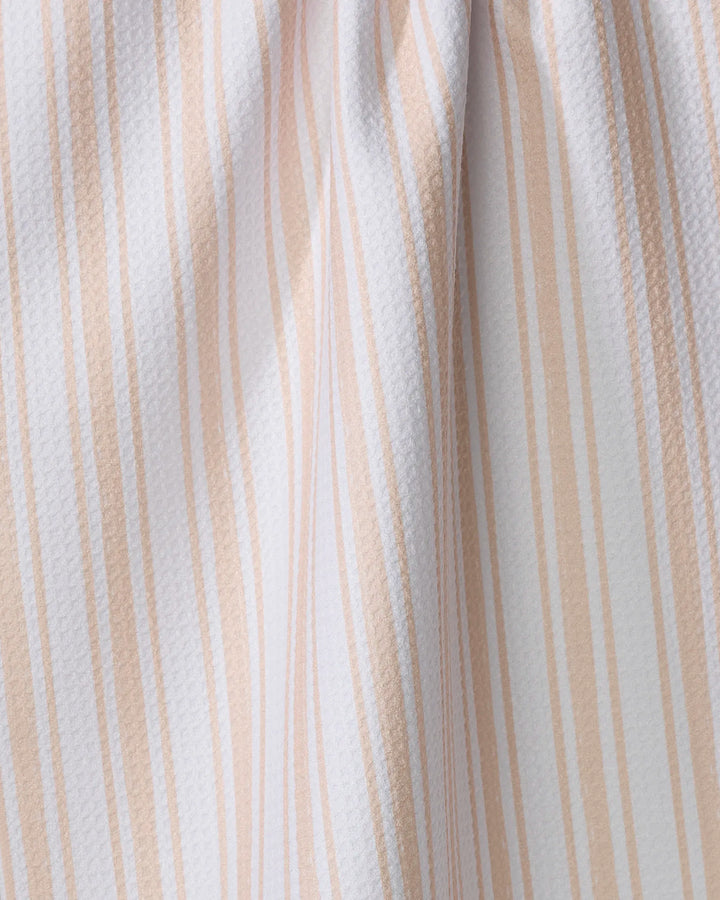 Close-up of the Hufton Studio Boho Stripe recycled kitchen towel, featuring white fabric with vertical beige stripes and a subtle textured pattern, highlighting gentle folds and shadows.