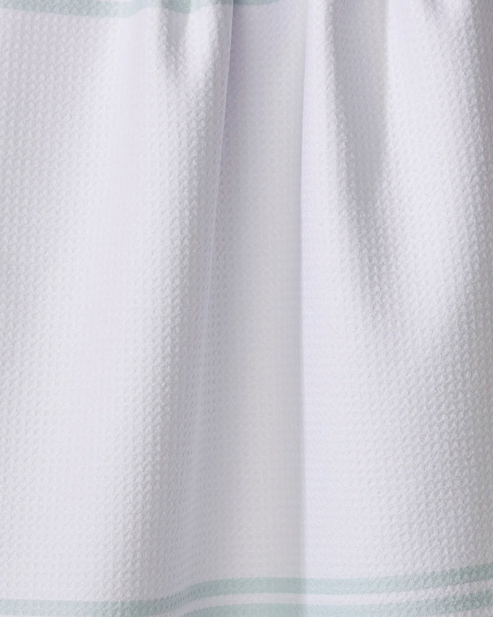Close-up of The Buy Guide’s Bold Blank Space - Mint tea towel, featuring a white textured fabric with subtle mint stripes near the top and bottom. The ultra-absorbent towel is shown slightly gathered at the upper edge.
