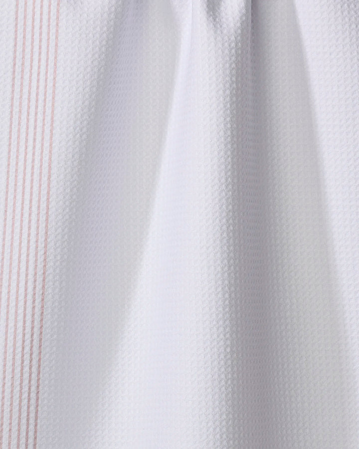Borderline - Dusty Rose by The Buy Guide features white textured fabric made from recycled materials, accented with subtle vertical dusty rose stripes along the left edge and softly draped for a gently gathered look.