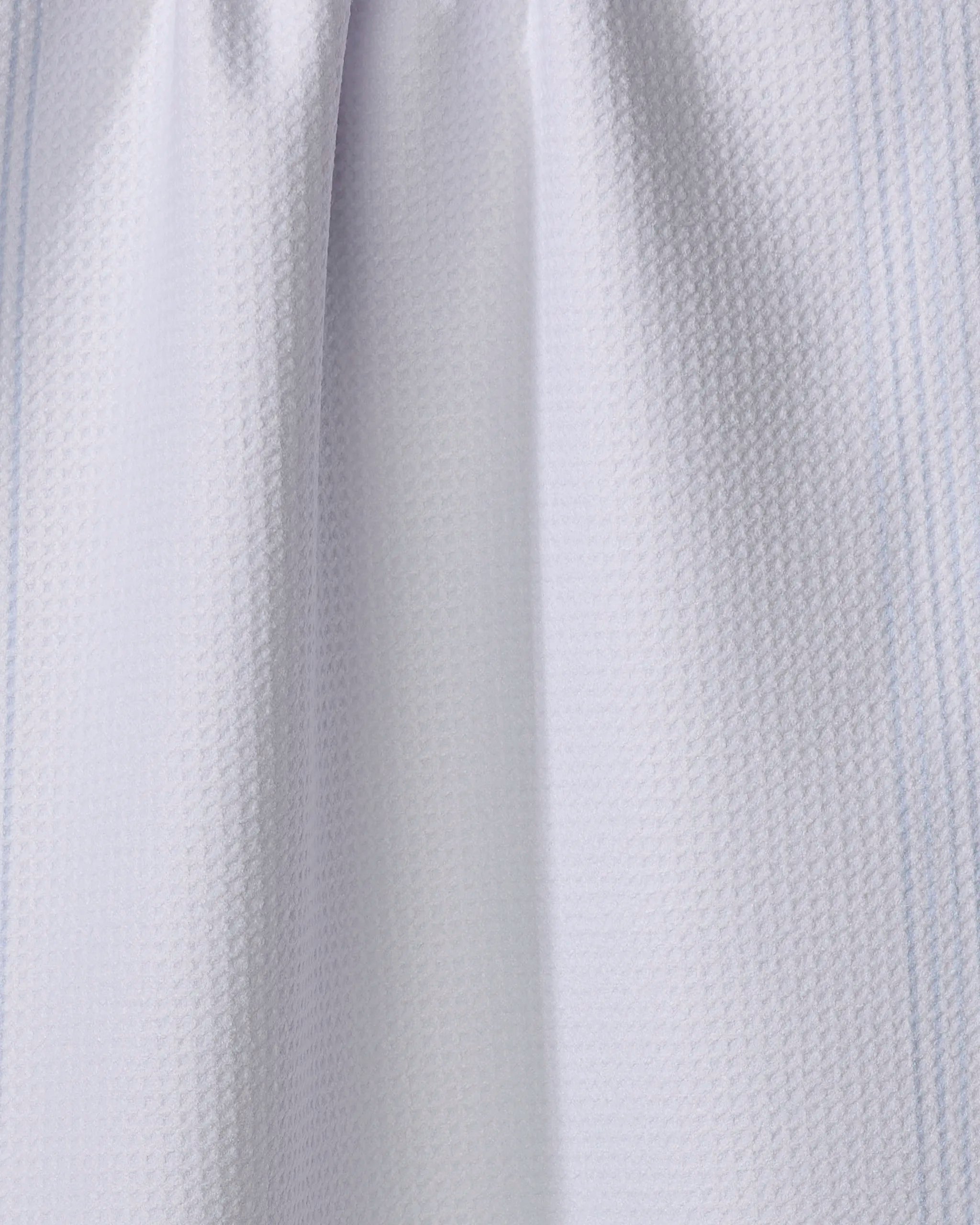 Close-up of The Buy Guide’s Borderline - Light Blue tea towel, showing its ultra-absorbent fabric with a subtle grid pattern and soft folds that add gentle shadows and depth.