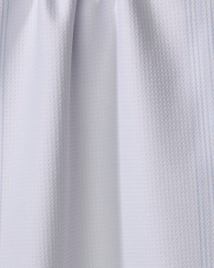 Close-up of The Buy Guide’s Borderline - Light Blue tea towel, showing its ultra-absorbent fabric with a subtle grid pattern and soft folds that add gentle shadows and depth.