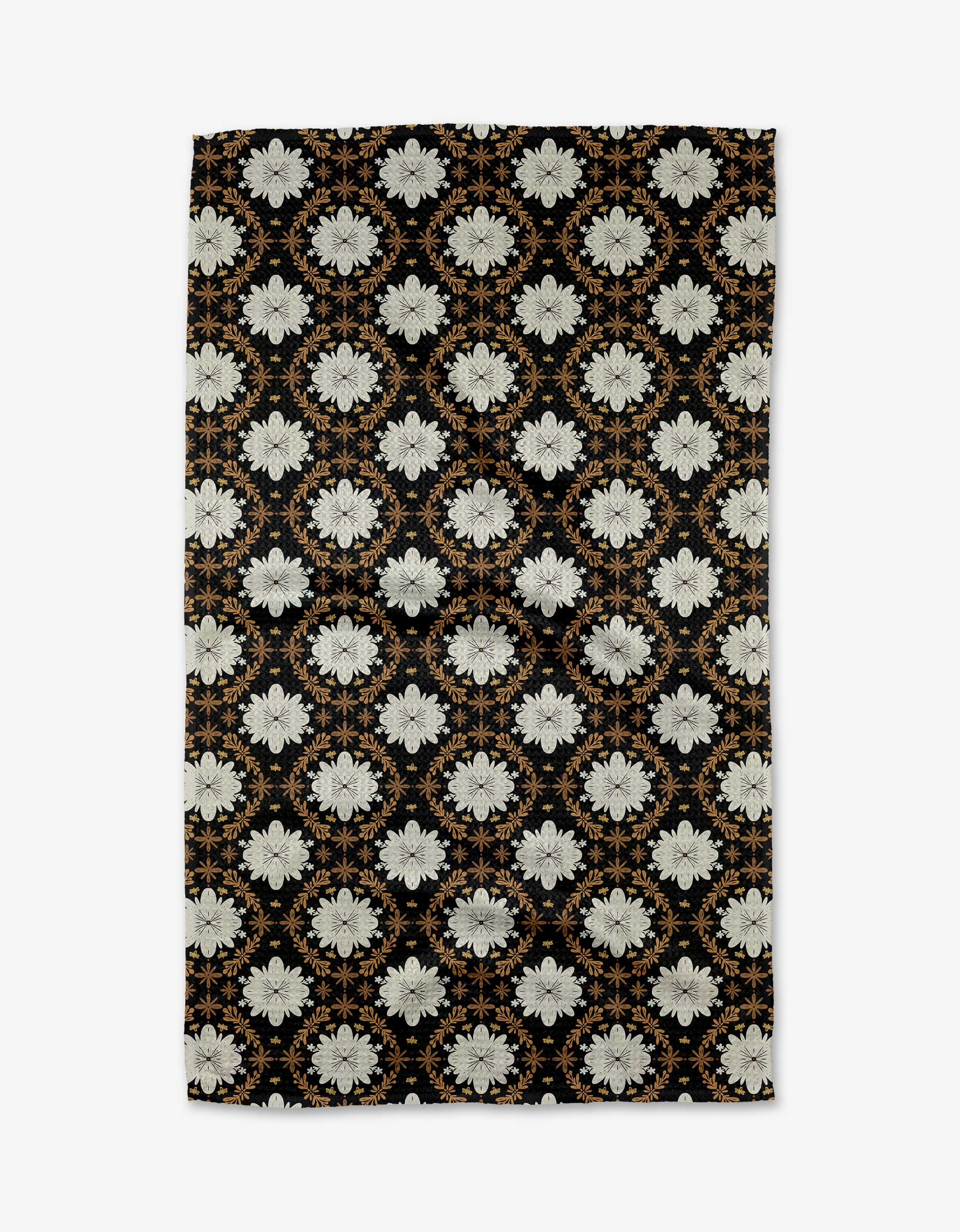 The Botanical Mosaic tea towel by Danelys Sidron features a rectangular Geoweave fabric with a symmetrical pattern of white flowers and gold accents on black, creating an elegant look for your kitchen.