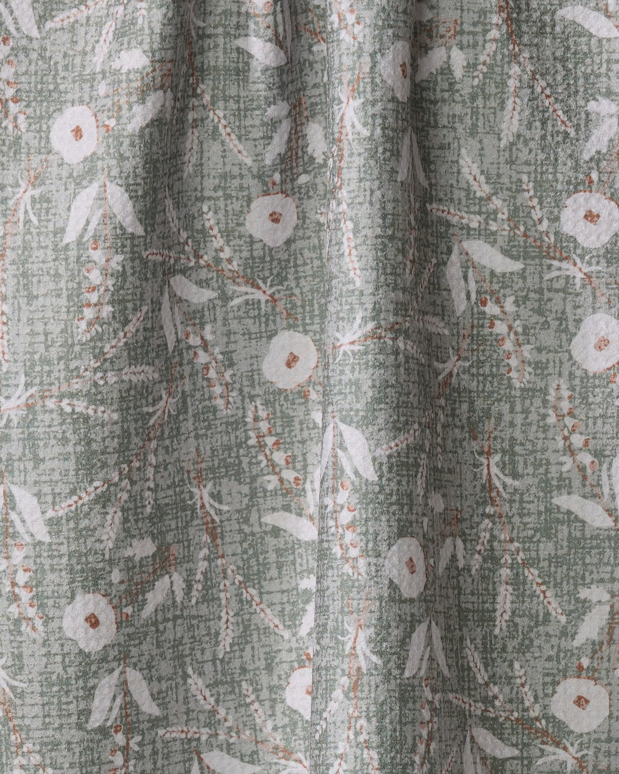 A close-up of Boyce Sage by Becki Owens shows green recycled fabric with a textured background, featuring a white floral and leaf pattern accented by brown stems and small dots.