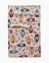 Bright Spot by Twig + Spark is a cozy fabric with vintage lanterns in red, yellow, blue, and teal alongside small leaves and branches on light beige—a perfect choice for a kitchen tea towel.