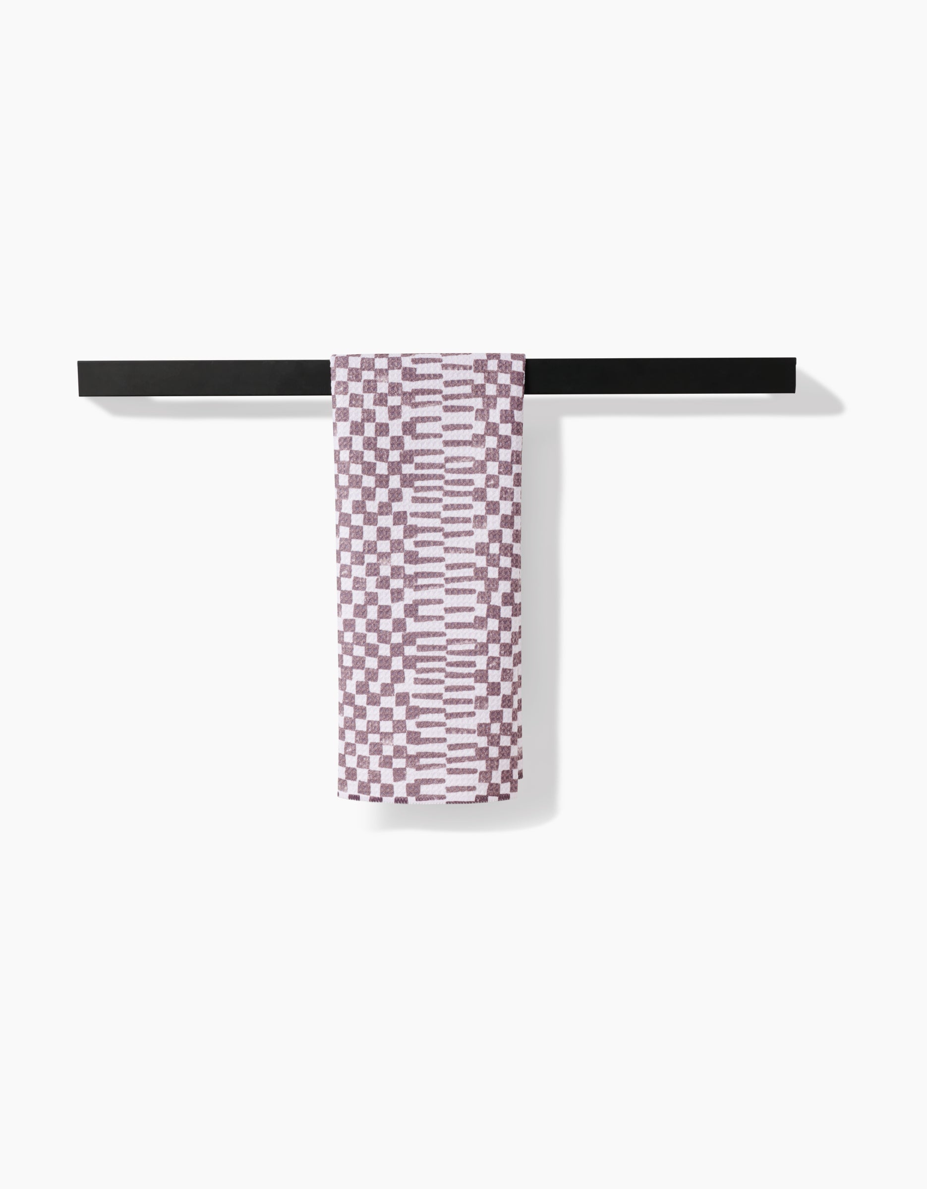 A bag of Chutes Coffee by Studio Jeannot is displayed on a plain white background, positioned neatly atop a simple black horizontal surface.