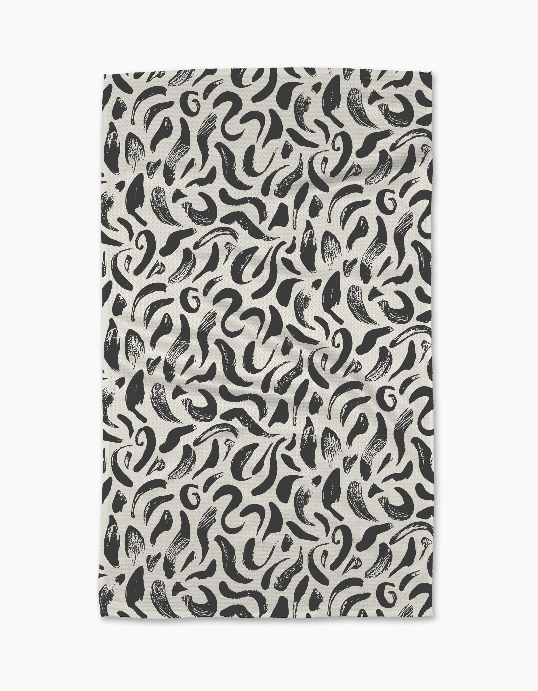 The Brush Strokes Swirls tea towel by Sarah Daugherty features a black and white abstract pattern on an off-white background. Made from recycled materials, it offers a stylish and sustainable choice for your kitchen.
