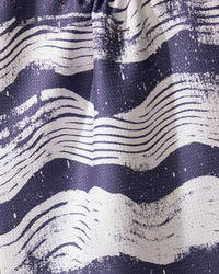 A close-up of Geometrys Brushline Navy tea towel, featuring quick-drying fabric and wavy, hand-drawn white stripes on a dark blue background for a dynamic, artistic texture.
