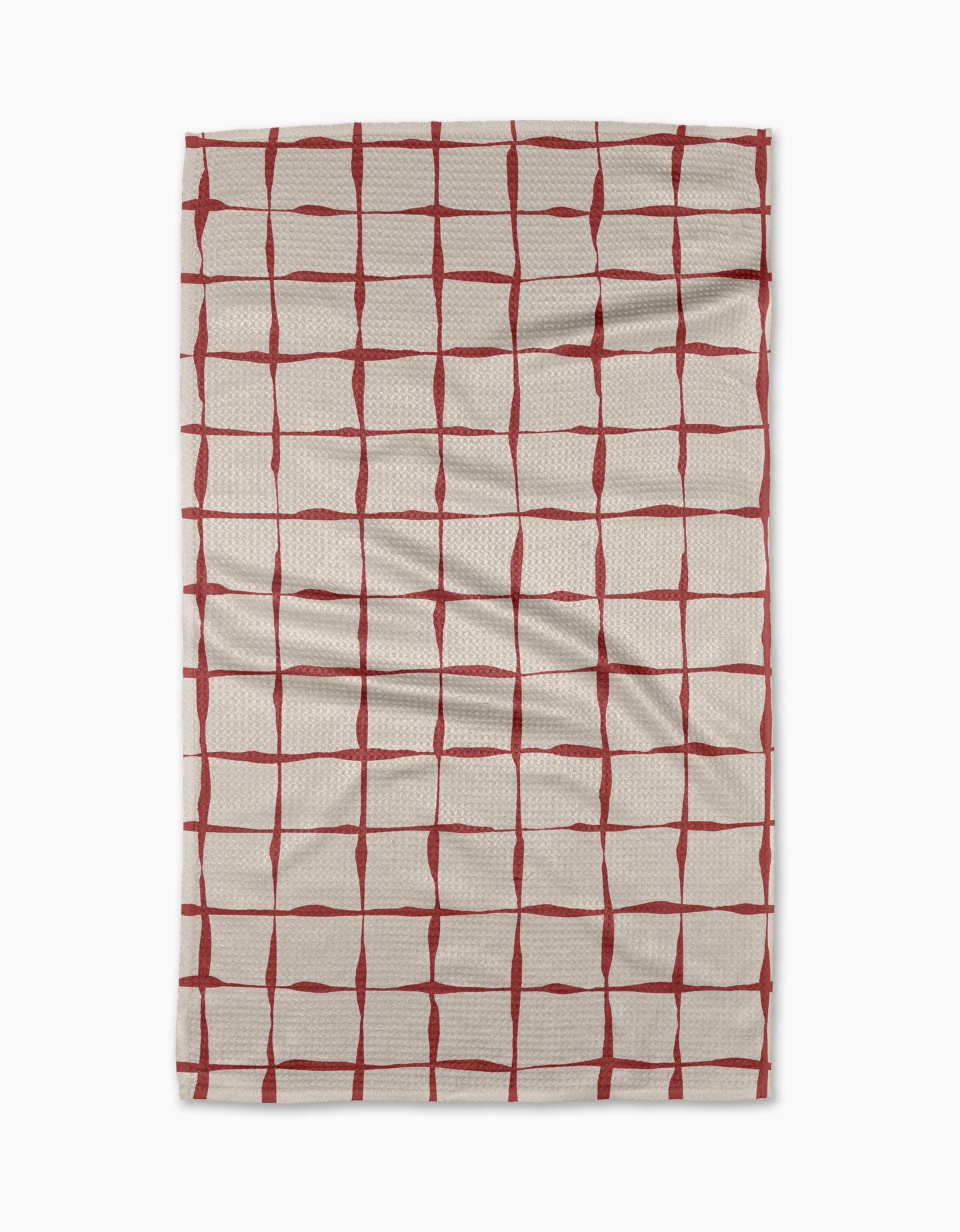 The Brushstroke Checks kitchen towel by Linda Fox is a beige, recycled fabric towel with irregular red grid lines and visible surface creases.