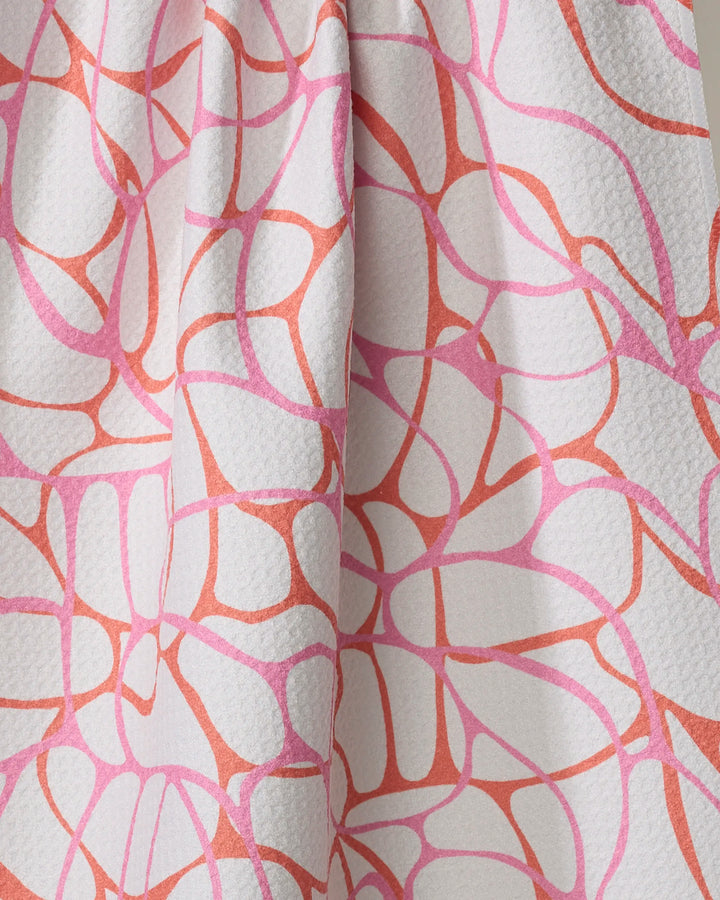 Close-up of the Rachel Parker "Bubble Abstract" tea towel, made from recycled materials with a white textured fabric and organic, web-like pink and coral abstract lines. Ultra-absorbent and eco-friendly design.