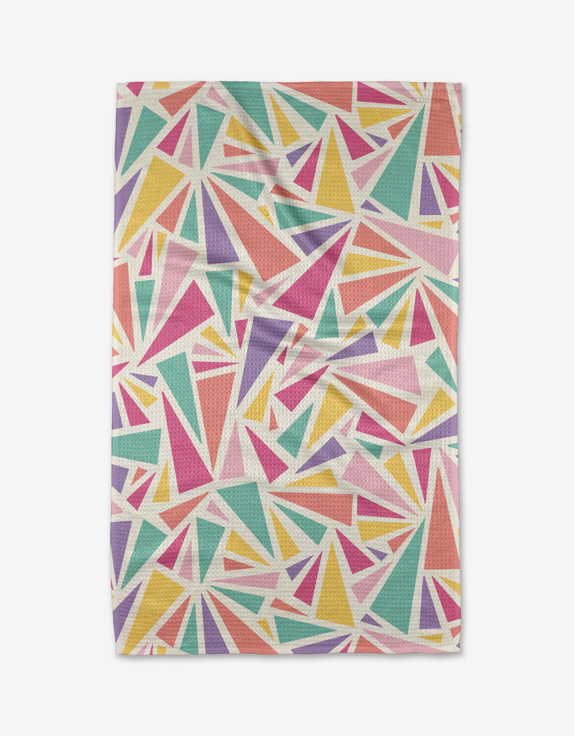 The Burst tea towel by Rebecca Bobko features a vibrant geometric pattern of multicolored triangles on white, with a slightly wrinkled surface—perfect for adding playful color to any kitchen.