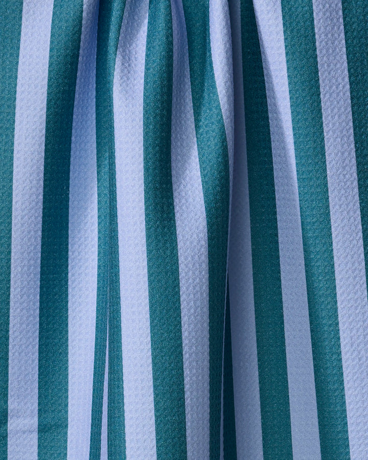 Close-up of The Buy Guide’s Cabana Boy - Emerald French Blue towel, featuring ultra-absorbent texture and vertical teal and white stripes with soft, gentle folds.